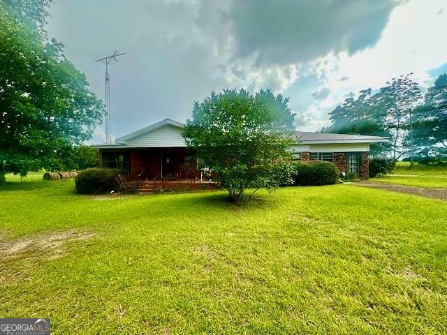 Need the peace and quiet of the Country? Next to open fields in a small rural town? ALL brick home with exterior storage building, and 3-car carport on level lot. Could remodel and open this home up and have a large entertaining area instead of two separate areas. 3 bedrooms, 2 baths, and currently has a sauna area (seller doesn't know the condition of the sauna). Approx. 14 miles from well-known Bass fishing at Lake Eufula. Proof of funds required to show. Thank you.