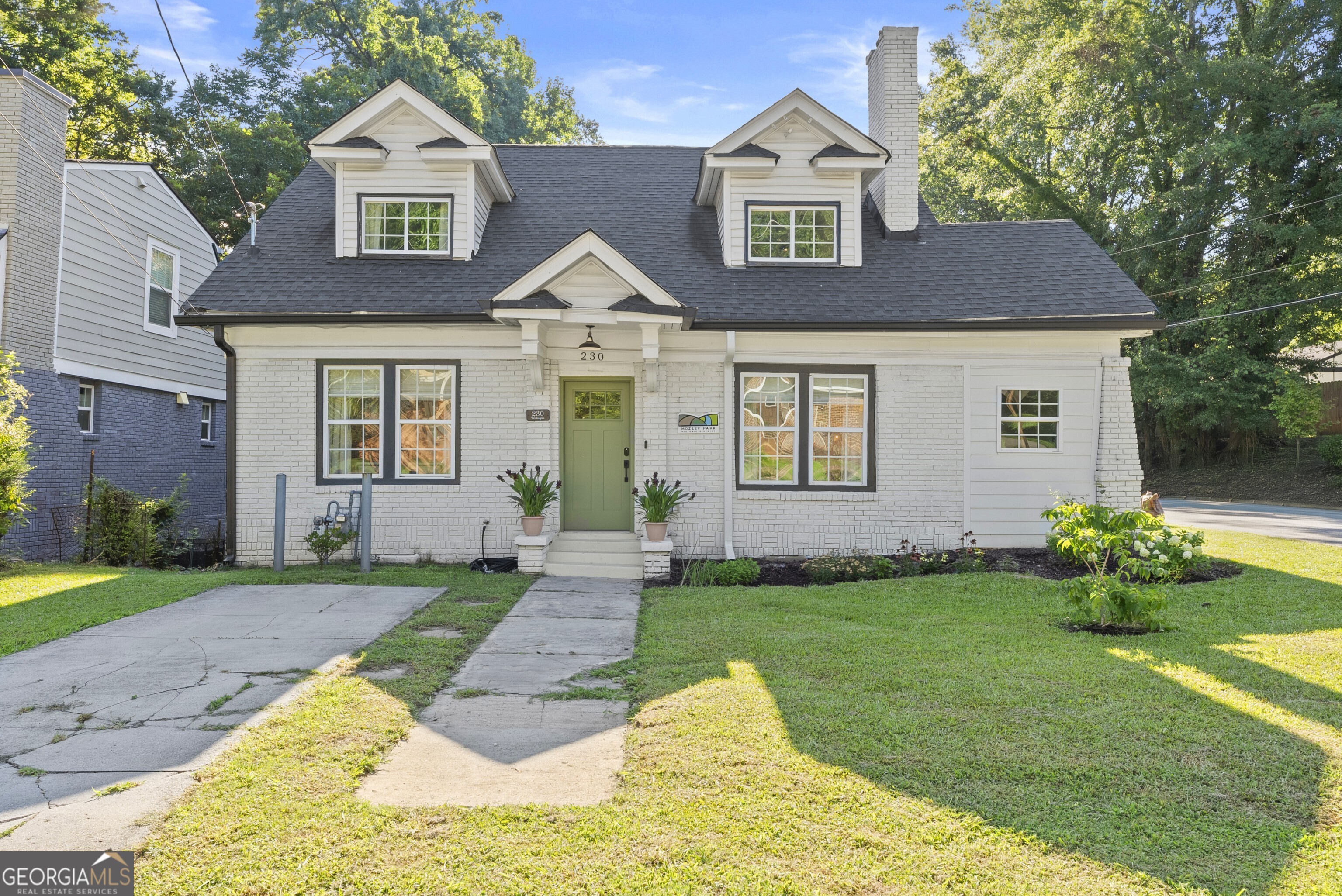 Welcome home to this beautifully renovated 1940s bungalow in sought after Mozley Park - one of Atlanta's most vibrant and rapidly growing neighborhoods! Blending timeless charm with modern updates, this 3-bedroom, 3-bathroom home offers in-town living just a 10 minute walk to the Westside BeltLine and minutes from Atlanta's hottest Westside spots. Fully renovated in 2019, the home features a bright, open floor plan with a main-level primary suite complete with a walk-in closet, double vanity, and custom-tiled shower. Upstairs, two spacious bedrooms share a Jack-and-Jill bath and offer ample closet space, along with access to the bonus attic for additional storage. Need extra room? The finished sunroom makes the perfect home office, gym, or flex space. At the heart of the home is a stunning kitchen with quartz countertops, stainless steel appliances, and plenty of cabinetry, plus a mudroom with laundry that leads to the back deck. Step outside to enjoy the private, fenced corner lot with a deck and patio ideal for relaxing or entertaining. Major systems, plumbing, and electrical were updated in 2019, so you can move in with confidence! Located just minutes from downtown, MARTA, Mercedes-Benz Stadium, and some of the city's best dining, coffee shops, and breweries, including the locally owned favorite Westview Corner Grocery, this home offers the perfect blend of character, comfort, and convenience. Don't miss your chance to own this stunning Mozley Park gem!