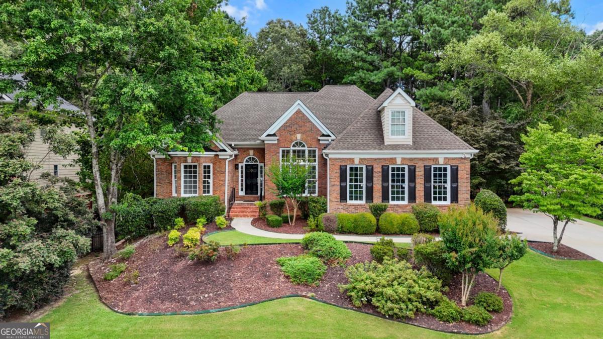 Welcome to 1751 Mulberry Lake Drive - a beautifully renovated and rare four-sided brick ranch with a full basement, located in the coveted Lakeside section of Hamilton Mill! This home offers timeless curb appeal and modern elegance throughout. Inside, you'll find all-new hardwood floors, new windows, fresh designer paint, and updated lighting that enhances the natural light flooding every room. The spacious master suite on the main level features dual walk-in closets and a luxurious primary bath with all-new finishes. The heart of the home is the gourmet kitchen, completely renovated with contemporary style and functionality in mind, flowing seamlessly into open-concept living spaces ideal for entertaining. Enjoy outdoor living on the huge new deck overlooking a level, fenced backyard-perfect for play, pets, or peaceful mornings. The expansive daylight basement offers endless possibilities: a home theater, workshop, extra living space, or additional bedroom suite. Ideally situated within walking distance to Hamilton Mill's premier swim & tennis amenities, with lake views just steps away, this is truly one of the best locations in the neighborhood. Don't miss this rare opportunity to own a move-in-ready gem in one of Gwinnett County's most sought-after communities. This is a MUST SEE!