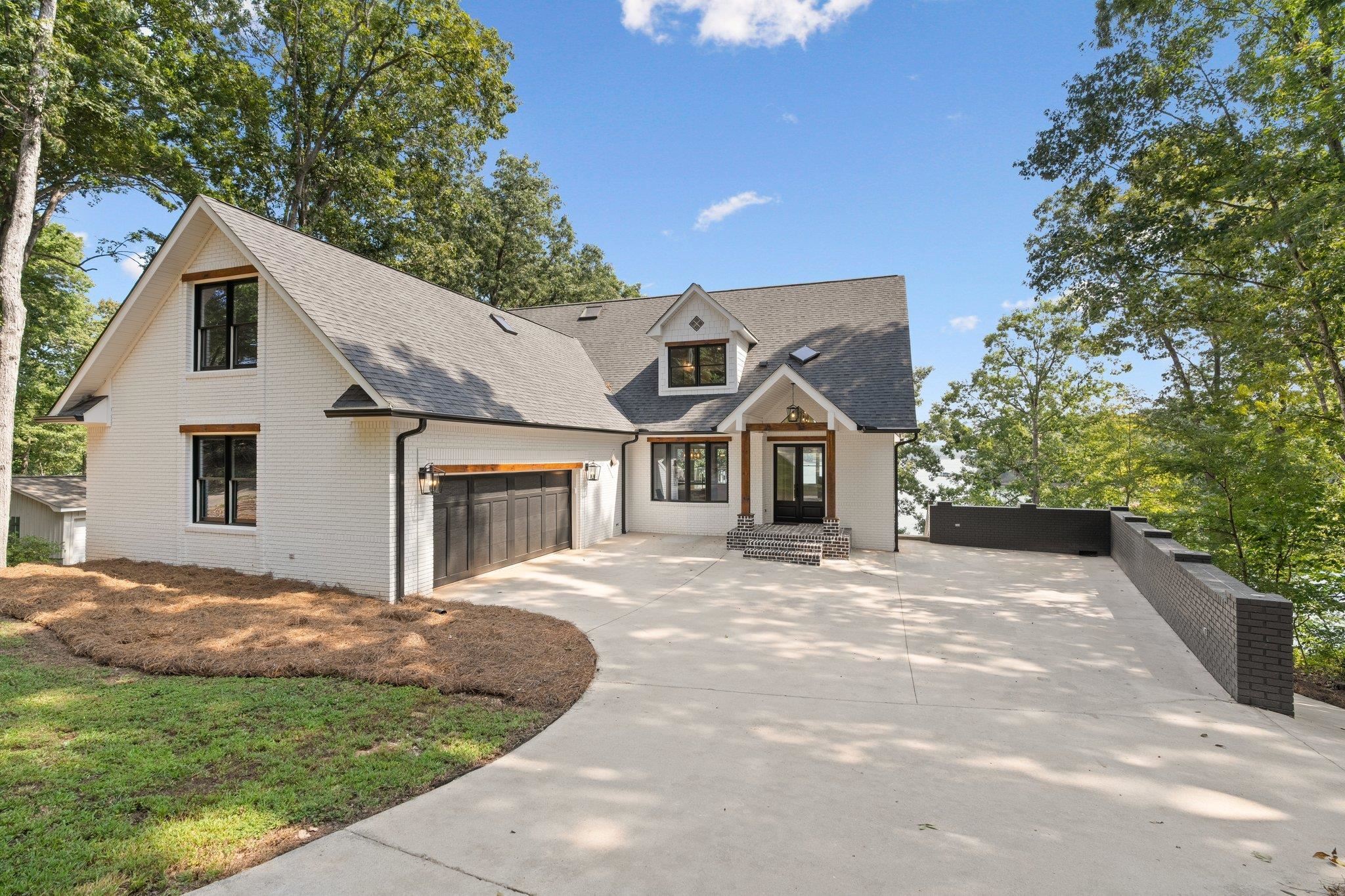 The ultimate Lake Hartwell home awaits. 4 finished floors of enjoyment resides in one of the best and most desirable areas of the lake. Reed Creek Point is known for deep water and long elevated views. Closing in on 7,000 finished sq feet, this 5 bed w/bonus 6 bath home features high end finishes throughout, custom tiled baths, white oak hardwood flooring, 2 living rooms, massive home theater room, gaming areas and much more. This lot produces amazing views of the lake from the home and the 3 levels of decks. There's nothing like this one out there, it's truly one of a kind! Don't miss out on the ultimate Lake Hartwell home!