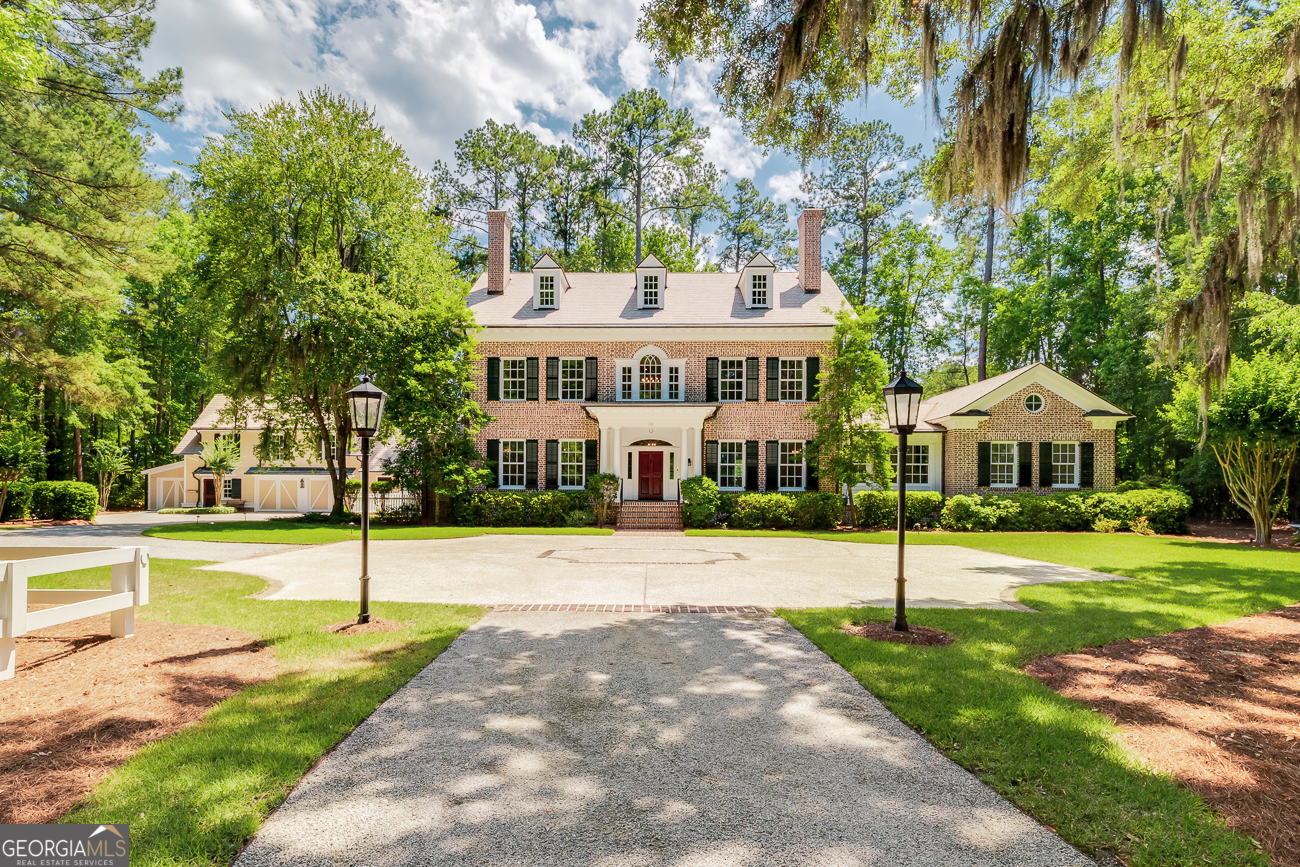 Experience the rarest blend of privacy, luxury, and natural beauty at this nearly 3-acre Estate in The Ford Field & River Club. Positioned on a premier lot with lake and golf views, this custom-built home (4955sf) with carriage house(2190sf) is a true sanctuary. The main house features a grand entry, first-floor owner's suite, NEW roof, HVAC, quartz countertops, fresh paint and upgraded lighting! The 2BR cottage includes a home office/gym, workshop, and garden room-perfect for creativity. Both homes offer amazing hardwood floors and the serenity of screened porches w/ views of the water and golf course. Full-property generator. Charming gas lanterns and wraparound drive welcome you. Just steps from The Ford's world-class amenities: Henry Ford's historic home, clubhouse, award-winning golf, dining, spa, equestrian, pool, tennis, pickleball, marina, fishing, and more. Gated & 24/7 security. 30 min to Savannah; 20 min to airport. Own one of the finest homes in this sought-after community!