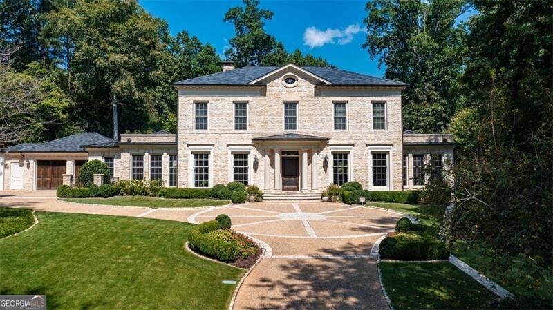 Discover unparalleled luxury in this exquisite Georgian-style estate, located in the heart of Buckhead, within the prestigious gated community of West Paces Park, Atlanta. This opulent Buckhead residence is an ideal investment for those seeking the epitome of privacy, elegance, and state-of-the-art amenities in a luxury home in Atlanta. Situated in the cul-de-sac of a quiet street among 11 distinguished homes, this estate offers the pinnacle of privacy on a sprawling 1.74-acre lot. The exterior boasts a timeless stone facade complemented by a durable slate roof, setting the stage for the tasteful elegance inside. Upon entry, the captivating marble floor design in the foyer welcomes you, leading to expansive living areas adorned with ten-foot ceilings and rich hardwood flooring. The home features four generously sized bedrooms, each with ensuite baths, including a lavish primary suite complete with a custom closet and beautiful, spa-like bathroom. An additional bedroom with an ensuite bath on the lower level. Designed for a lifestyle of refinement and relaxation, the home's exterior features a professionally landscaped garden yard and flower garden, a saltwater pool, and multiple outdoor entertainment spaces. Additional lifestyle amenities include a state-of-the-art home theater, a wine cellar, and a fully equipped home gym. No modern conveniences were overlooked; the property is equipped with a whole-home generator and an elevator, facilitating a seamless living experience. The gourmet kitchen and adjoining keeping room feature a butler's pantry and a cozy fireplace, rounding out the home's luxurious offerings. With a three-car garage and a guest parking area further enhancing convenience, this Buckhead estate is the epitome of luxury living in Atlanta. Taxes do not reflect a Homestead Exemption.