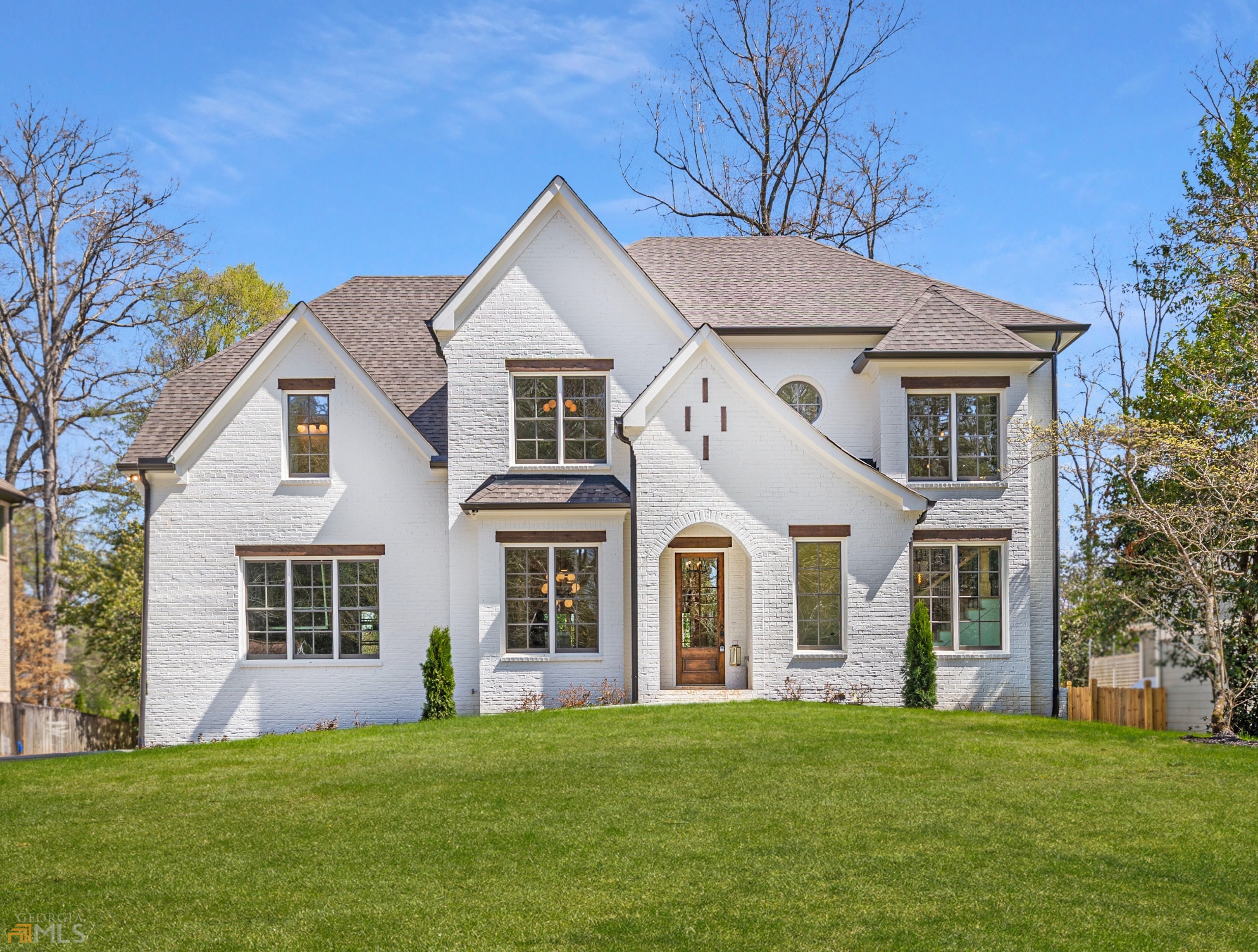 Incredible new construction home nestled in the heart of Brookhaven and walkable to Ashford Park Elementary school. This location cant be matched! This home has loads of curb appeal from the moment you pull into the driveway with professional landscaping, a beautiful bright exterior, and a 3-car garage side entry garage. The foyer is dressed to impress with a dazzling staircase with accent wall and floor-to-ceiling windows. This entertainer's dream features a spacious family room w/ an inviting fireplace, and abundant light pouring in from the large windows. The kitchen is complete top of the appliances, large island w/ seating, custom cabinets, walk-in pantry, and views to the immaculate backyard. To finish off the main level, there is a large dining room, guest bedroom with a full bath, powder room, and relaxing outdoor porch. The owner's suite on the 2nd level has a large custom closet and a private spa-like bathroom with a wet room and custom double vanity. Three secondary bedrooms w/ their own private bathrooms and a laundry room complete the 2nd level. There is also a large unfinished daylight basement perfect for a rec or media room with tons of extra storage space.