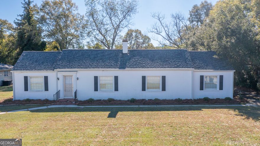 Welcome to 17942 Main St, Woodbury, GA! This charming 3-bedroom, 2-bath home features a painted white brick exterior and a new roof. Enjoy wood floors throughout, with tile and LVP in the kitchen and bathrooms, plus fresh interior paint throughout. The spacious living and dining areas are perfect for entertaining, highlighted by a sunroom with terra cotta tile floors and a unique double-sided fireplace shared with one of the bedrooms and the living room. The kitchen boasts butcher block countertops and all stainless steel appliances, included with the home. Additional features include a 2-car garage with a breezeway, an attached shop, an asphalt driveway with ample rear parking, and a partial unfinished basement ideal for storage. This home combines style, functionality, and plenty of space for everyday living and hobbies.