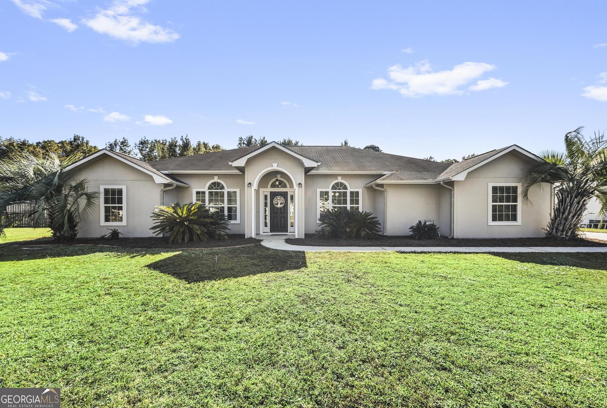 You could be HOME for Christmas! 4-BR, 2-BA home located in a low traffic cul-de-sac within a popular neighborhood, just a short 15-minute drive from Kings Bay Naval Base. This spacious residence features over 2400+/- sq ft heated/cooled, plus an additional 250+/- sq ft Sun Room, a 550+/- sq ft side entry Garage and a Fenced Back Yard. This has been HOME to just one family since 2005 and now, it’s ready for YOURS. Many guests have been greeted in the wide Foyer entrance and memorable conversations had over dinner in the Formal Dining Room that’s highlighted with archways, columns, crown molding and large picture windows. Adjacent to the dining room you’ll find the Office, with soaring ceiling, palladium window and archway where homework was completed and remote work was made easy. The centrally located Family Room is the hub of all gatherings, whether cozying up for a movie or hosting bustling game nights, there is plenty of room for all people and multiple furniture arrangements. The thoughtful Split Floor Plan has ensured privacy and convenience for all occupants. On one side of the home are 3 sizable Guest Bedrooms and the Guest Bath, with linen closet, double vanity and dual sinks. On the opposite side, The Owner's Bedroom is a true retreat, featuring a tray ceiling and a Private Bathroom with relaxing corner soaking tub, separate shower with dual shower heads and seats, a double vanity and a generously sized walk-in closet. In addition to the indoor living space, this Home offers a 250+ sq ft Sunroom, perfect for expanding entertainment space, play space or separate pet space. The 2-car side entry Garage, spanning 550+ square feet, provides ample space for vehicles, storage and workspace. Pets and children have played safely in the Fenced Backyard, where you can create your own oasis and enjoy outdoor activities. The property is not only conveniently located near top-rated schools, shopping and dining, it also offers easy access to Interstate 95: 25 +/- miles away from the beach and JAX Airport and under an hour from nationally top rated health care. Please note that a new architectural shingle roof will be installed, helping to ensure the longevity and durability of your investment. Special conditions apply, so don't miss this chance to make this exceptional house your new Home for the Holidays and start creating YOUR lifetime of memories.