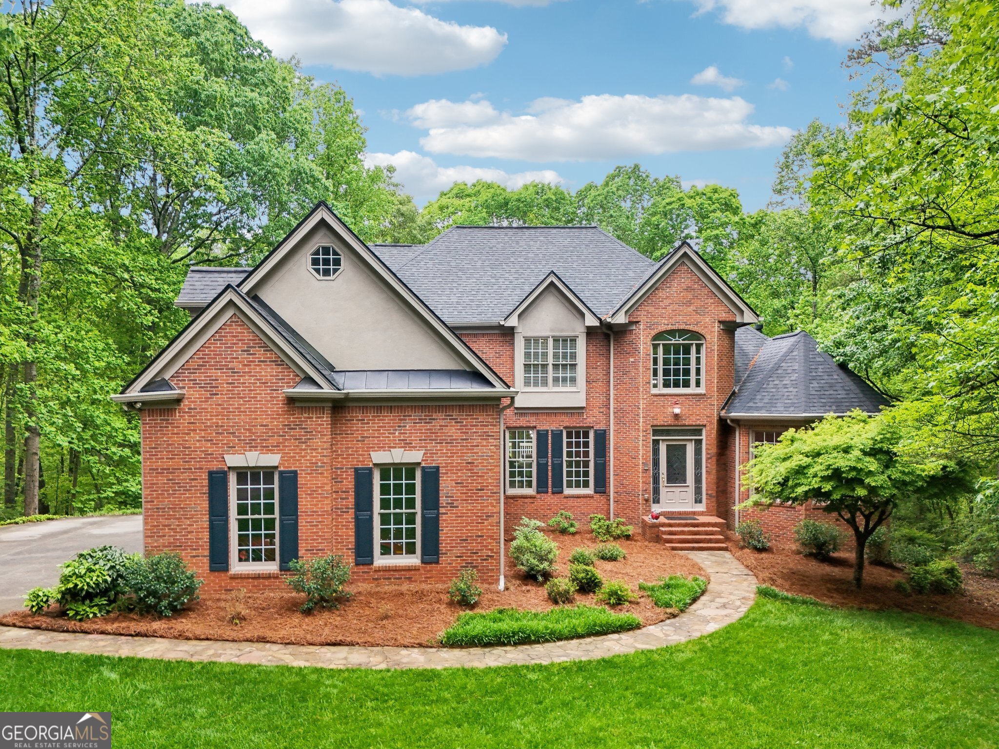 3-sided brick beauty on a lush, 2.33 acres cul de sac lot on the fast-flowing James Creek! Don't miss this one, folks! It is set back off the road among tons of trees with lots of privacy and nature. Side entry 3-car garage. Gorgeous kitchen renovation with new cabinetry, quartz countertops and stainless steel appliances and farm sink. Cozy keeping room with fireplace and lots of windows. Grand 2-story family room with soaring ceiling and fireplace. Master on the main. Three additional bedrooms and 2 full baths upstairs. Finished basement with TWO bedrooms and TWO full baths and rec room. Plenty of storage. French doors in the basement lead out onto a patio with dry-below under the deck. Now can we talk about this beautiful lot?? Acreage in South Forsyth! WOWZA! And it's waterfront! Separate fenced-in area of the backyard for the kids or pets. Bring the family to see this awesome place to call HOME! NEWER ROOF AND GUTTERS, NEW WINDOWS, NEWER HOT WATER HEATER, BRAND SPANKING NEW HVAC SYSTEMS.. JUST WAITING ON YOU!