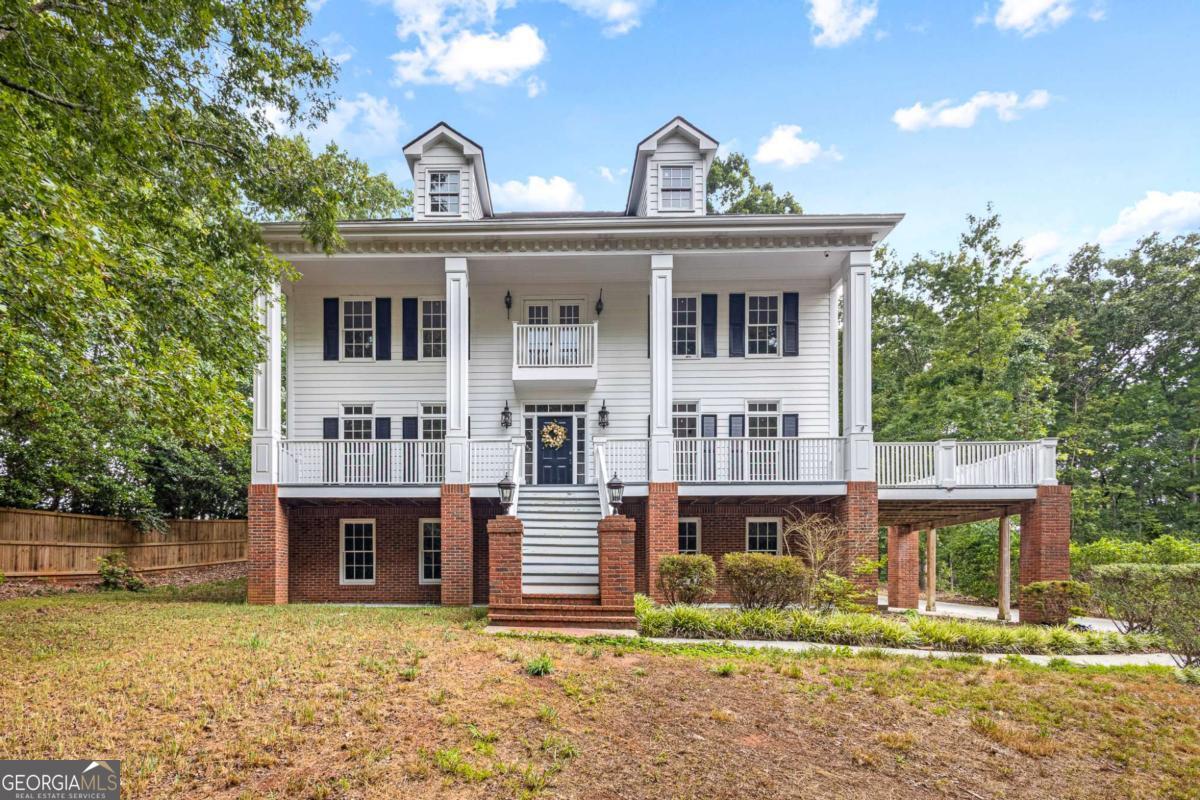 Welcome to this stunning, character-filled home that seamlessly blends timeless charm with modern updates. From the moment you arrive, you'll be captivated by the elegant exterior featuring stately columns and a grand front staircase that leads to a covered wrap-around porch-perfect for morning coffee or evening relaxation. Step inside to soaring ceilings and an inviting staircase that sets the tone for the home's open and airy layout. The main level features a flowing floor plan with a formal dining room ideal for entertaining, and a spacious kitchen that opens to the living room for effortless gatherings. The kitchen is a chef's dream, complete with granite countertops, stainless steel appliances, double ovens, and ample cabinetry. Upstairs, retreat to a luxurious master suite that boasts an abundance of natural light, a large walk-in closet, and a spa-inspired en suite bathroom with dual vanities, a soaking tub, and a tiled walk-in shower. Additional bedrooms upstairs are generously sized with brand new carpet. The walkout basement offers incredible flexibility with an additional bedroom and full bathroom-perfect for guests or extended family. Already plumbed for a kitchenette, this space is ready to become a mother-in-law suite, recreation room, or home bar-the choice is yours. Additional features include fresh interior paint, recessed lighting, and modernized bathrooms throughout. The home also includes three garage spaces, offering ample room for vehicles and storage, and sits on a well-sized yard ready for your outdoor plans. Don't miss your chance to own this character-rich home with exceptional space, style, and functionality!
