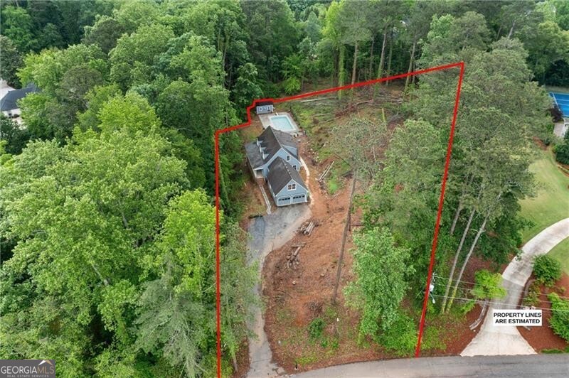Builder/Developer Opportunity - 1.2 Acres in Prime East Cobb Location! Located near Paper Mill and Johnson Ferry, this rare 1.2-acre sloped lot offers exceptional potential for a custom luxury build in one of East Cobb's most prestigious areas. The property has already been cleared of trees, providing a head start for development, and the natural elevation allows for creative architectural design-ideal for homes with walk-out basements or multi-level layouts. An existing 4-bedroom, 2.5-bath structure sits on the lot and could be renovated or removed to make way for new construction. Surrounded by high-end homes and zoned for award-winning schools, this site is just minutes from fine dining, shopping, the Chattahoochee River National Recreation Area, Atlanta Country Club (ACC), and hiking. Opportunities like this are increasingly rare-don't miss your chance to build in one of Cobb County's most sought-after neighborhoods!