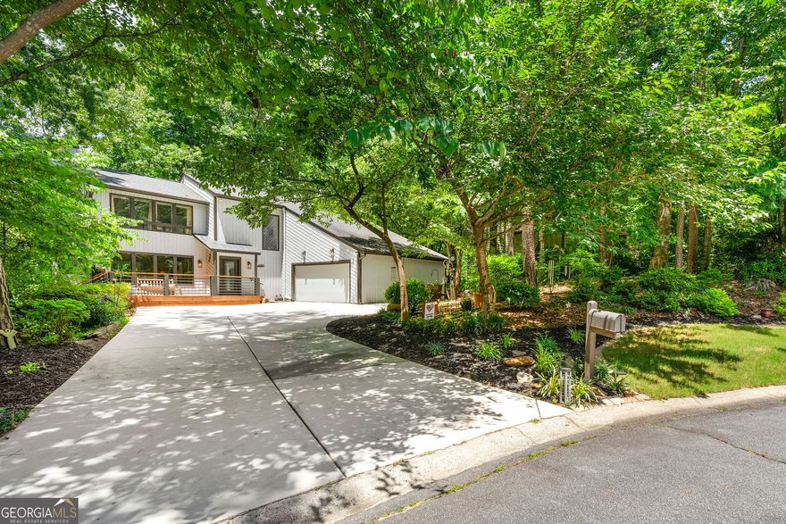 Nestled in a quiet cul-de-sac on a level lot in the highly sought-after lake community of Loch Highland, this home combines contemporary curb appeal with a warm, traditional interior while blending effortlessly into the peaceful, mountain-like surroundings of one of East Cobb's most scenic and established neighborhoods. Inside, the home features a fireside family room, a crisp white kitchen, and a separate dining area-perfect for everyday living or entertaining guests. Upstairs, you'll find spacious secondary bedrooms and an inviting owner's suite with a beautifully renovated bathroom completed within the past two weeks. The finished basement provides even more space for entertaining or relaxing. Outdoors, the fun continues with space for games like cornhole and bocce ball, a side yard perfect for a playground and a deck made for grilling and watching the sunsets. Nature lovers will delight in frequent visits from deer, foxes, owls, hawks, and bunnies, and the home is an easy walk to the lake & amenities. Loch Highland is more than a neighborhood-it's a lifestyle. The HOA offers amenities such as swimming pools, tennis courts, a fishing lake, and a playground, all just minutes from top-rated Lassiter High School, shopping, and dining. With the roof, driveway, and water heater all replaced in the last 5 years plus more upgrades too long to list here, this home offers peace of mind and lasting value. Don't miss your opportunity to own a home in one of East Cobb's most beloved lake communities.