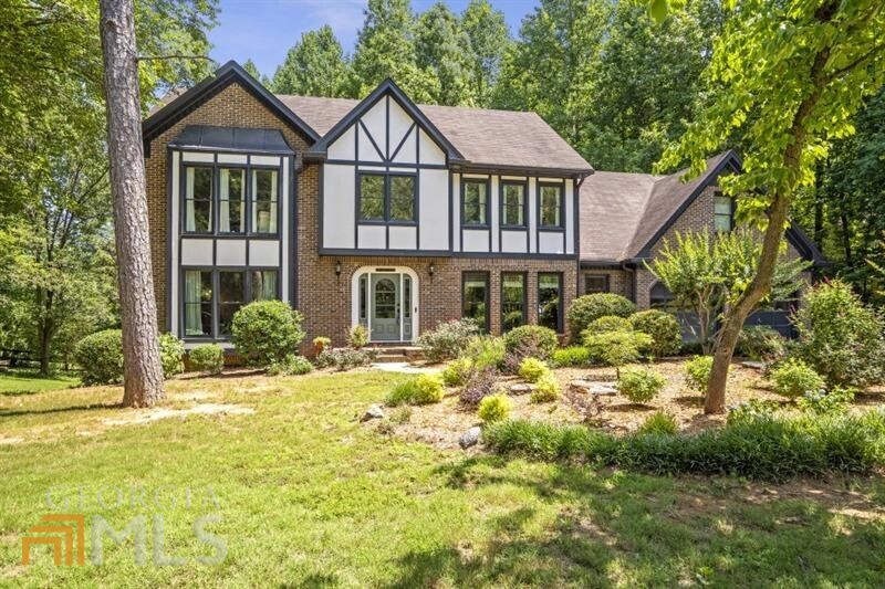 Beautiful Tudor in sought after swim/tennis Shallowford Park! Award-winning school district just minutes to Historic Roswell, shopping, dining, parks, and the Chattahoochee Rive recreational areas. The two-story foyer welcomes you into the bright first floor dining room, living room and fireside family room. The view to the updated kitchen features a bar sure impress! Enjoy mornings and evenings on the covered porch and entertaining guests on the large deck. The almost 3/4 acre lot extends well beyond the tree line which the current owners kept for privacy but could be cleared for even more yard space. The owner's suite is a true retreat complete with sitting area. The owner's bath boasts dual vanities, a separate shower and a jacuzzi tub. Two ample sized secondary bedrooms share the hall bath. A huge fourth bedroom with ensuite is ready for guests. The terrace level makes a perfect rec area and has a large unfinished space that could accommodate another bedroom, bathroom, movie theater, etc. A true gem in the heart of Roswell!