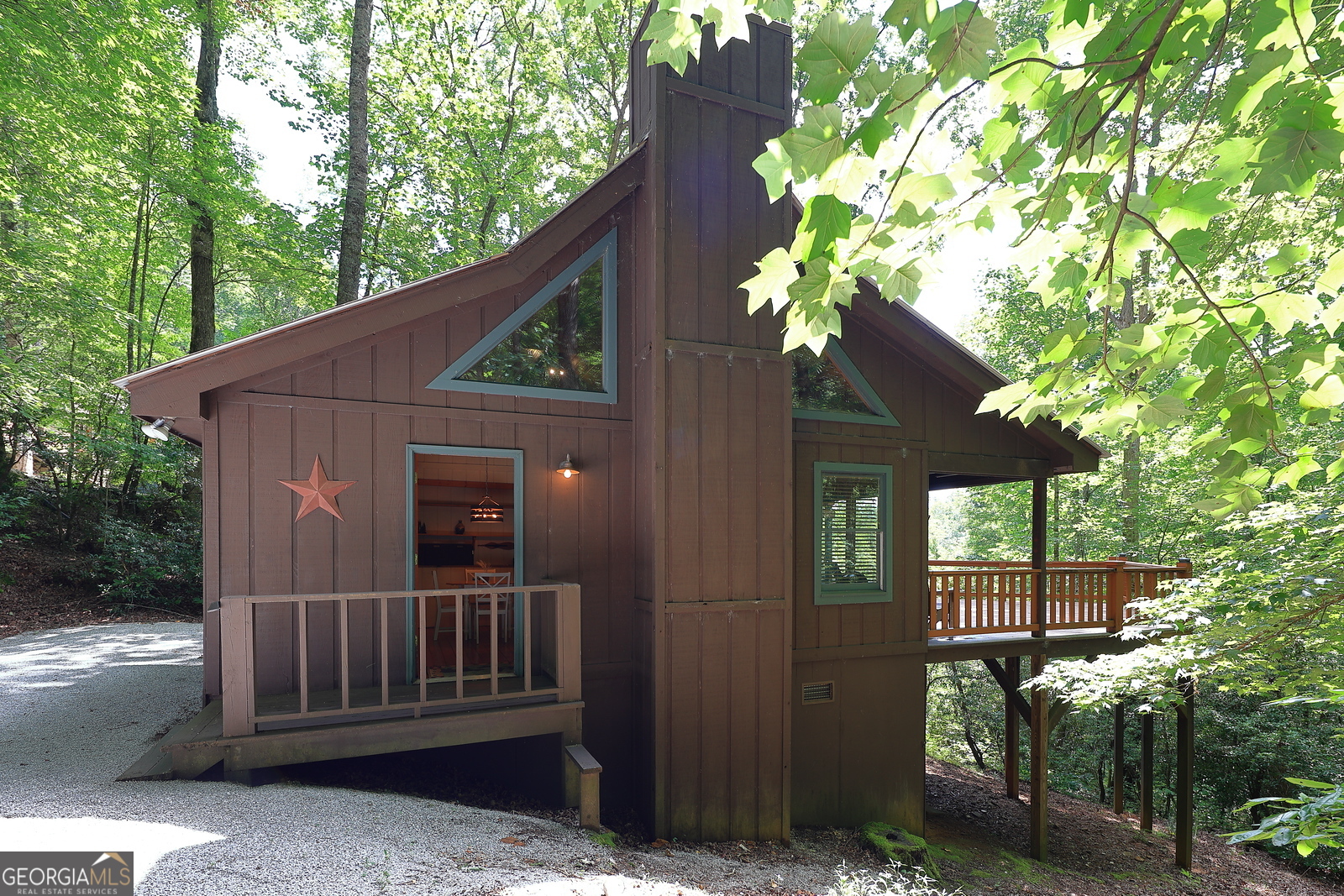Introducing this one bedroom, one bath plus loft getaway cabin nestled in the woods with Lake Burton access. Boasting pine flooring, cabinetry, and vaulted ceilings accented with white paneled walls, this charming cabin is the perfect spot to get away from the hustle and bustle of city life. The great room has a stone fireplace, built in cabinets and sliding door to a spacious partially covered deck with hot tub and party lights. The main floor bedroom offers white walls and beamed ceiling with natural pine trim, a daybed window seat and laundry closet. A laurel banister takes you to the loft area for office or extra sleeping. Extras include seasonal long distance mountain views and hardwood trees so the fall colors are exceptional! The newly renovated Get-A-Way's Lake Burton access makes Lake Burton living so enjoyable and affordable.