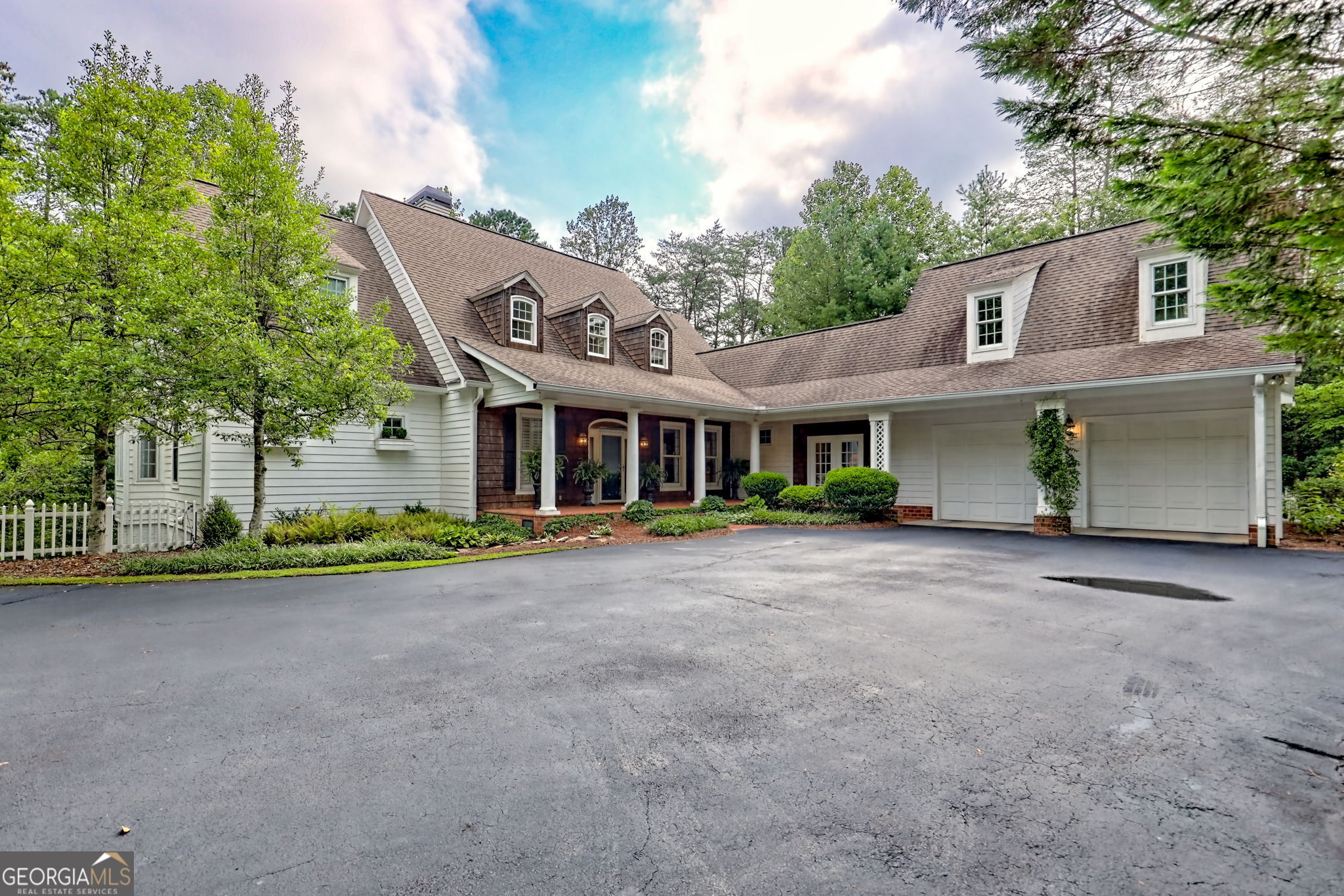 Conveniently set on two creekfront acres in the North Georgia Mountains and seconds from downtown Clayton, this updated Southern Living home blends timeless elegance with modern comfort. The formal living spaces are refreshed for today's lifestyle. A brick and shake entry opens to gorgeous interiors with large windows framing the laurel privacy of the surrounding landscape. The recent kitchen addition connects to the keeping room and through an enclosed breezeway to the garage and incredible bonus room. Entertain on multiple decks or just romp around the fenced backyard with private trails, great for pets. The main-level master suite offers a spa-inspired bath, dressing room, and expansive multi-room closet. Up the graceful staircase, find a loft-style nook and three more bedrooms, one with an en-suite bathroom. A full basement workshop, backup generator, and small greenhouse add practicality. Meticulously maintained, this is a rare year-round forever home, located close to Clayton's shops and restaurants.