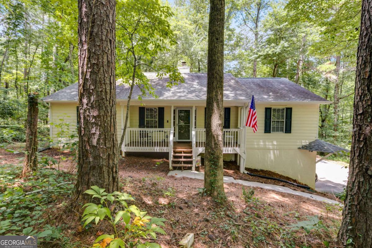 Charming Raised Ranch on 1.42 Private Acres - No HOA! Welcome to this beautifully updated 3-bedroom, 2-bath raised ranch nestled on a secluded 1.42-acre lot in Dallas, GA. Offering 1,649 square feet of heated living space, this home combines modern upgrades with peaceful surroundings-all with no HOA restrictions. Step inside to discover brand new flooring throughout and a fully renovated kitchen featuring new countertops and refurbished cabinets, perfect for preparing meals or entertaining guests. The back deck has been thoughtfully enclosed to create additional living space-ideal for a sunroom, office, or play area. The home also includes an unfinished basement, providing ample storage or future expansion possibilities. Located in the sought-after Paulding High School district, this property offers convenience to shopping, restaurants, medical facilities, and more-all while giving you the privacy of a wooded, tucked-away setting. Don't miss your chance to own this move-in ready gem in a prime location with room to grow.