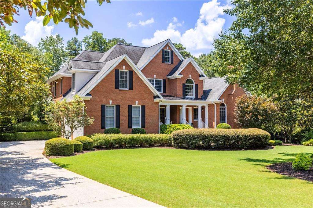 Refined Estate Living in Exclusive Oak Ridge on the Green. Discover the perfect blend of elegance, comfort, and resort-style living in this beautifully updated estate home, nestled within the highly coveted Oak Ridge on the Green-a private, no-HOA enclave in Milton, just north of Alpharetta. From the moment you step onto the welcoming rocking chair front porch, you're drawn into a home thoughtfully designed for both luxurious everyday living and effortless entertaining. The main level begins with a dramatic two-story foyer that opens into a vaulted great room, flanked by formal living and dining rooms rich with architectural detail. Hardwood floors, newly sanded and re-stained, flow throughout most of this level, creating a warm and cohesive space. At the heart of the home is a chef-inspired, Tuscany-style kitchen, fully reimagined with granite countertops, elegant tile backsplash, and brand-new stainless steel appliances, including a Wolf gas cooktop. A large island with a second cooktop, two pantries, a breakfast bar, and a sunny dining area provide both functionality and beauty-ideal for casual mornings or hosting friends and family. The expansive primary suite, located on the main floor, is a true retreat. It offers a spacious sitting area, direct access to the backyard, and a newly completed spa-style bathroom featuring high-end finishes and a serene ambiance. From the kitchen, great room, and primary bedroom, step outside to a covered patio that overlooks your private backyard oasis. This backyard is designed for year-round enjoyment, with a heated saltwater pool surrounded by new tile and stamped concrete decking. Multiple levels of covered patios provide ample space to relax or entertain, while a garden area basks in full sun. A winding woodland path leads to a firepit nestled beneath the trees and a whimsical, shaded space lovingly described by the owners' grandchildren as "Middle Earth." Upstairs, you'll find three generously sized bedrooms-one with a private bath and the other connected via a Jack-and-Jill bath-as well as a large media or office room. A hidden door reveals access to the unfinished attic, offering storage or the potential for future expansion. The fully finished terrace level is practically a home of its own. It includes a spacious great room with fireplace, a large office with a private sitting area, a full bath, and unique specialty rooms such as a custom wine tasting room, a sauna/massage room, and a fitness area. With endless flexibility, this level is ideal for multigenerational living, guests, or customized hobbies. Outside, the professionally landscaped backyard has been completely transformed. In addition to the pool and firepit, all drainage has been routed underground, preserving the beauty and integrity of the space through every season. The extensive list of updates-totaling more than $650,000-includes refinished floors and stair railings, all-new paint and carpet, updated kitchen and primary bath renovation, new high-end appliances, designer light fixtures and ceiling fans, a redesigned stone fireplace, new garage doors, a new pool liner and equipment with saltwater and heating conversion, new decking on the porches, updated irrigation systems, outdoor lighting, sauna, wine room, new HVAC systems, dual hot water heaters, attic fans, and much more. Located about seven miles from downtown Alpharetta, Oak Ridge on the Green offers a rare combination of privacy, tranquility, and convenience. With top-rated Milton schools nearby and easy access to GA-400, Avalon, and the best of North Fulton living, this exceptional home is a true sanctuary that brings resort living to your doorstep.