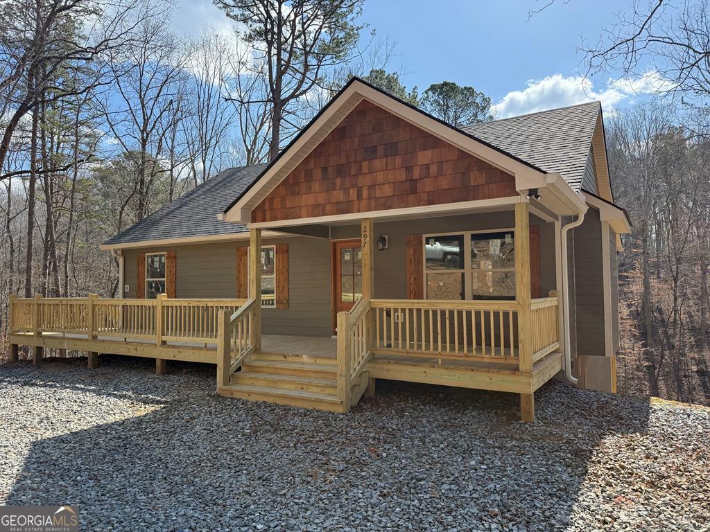 Who's looking for a recently completed new construction with loads of porch space, creek frontage and a circle drive? Walk into this beautiful home and the first thing you see is the rock fireplace in the living room, it fits perfectly with the wooden vaulted ceiling and the luxury vinyl flooring. Just past this is the eat in kitchen, complete with a pantry, all kitchen appliances and an island. Down the hall you see the full guest bath, 2 guest bedrooms and a great sized master suite. All bedrooms are vaulted and wood covered, nice sized closets and solid wooden interior doors. The master bath has a pocket door to save space and there's a small linen closet just a few feet away. The porches and decks offer both covered and open for all kinds of entertainment ideas and the creek has loads of flat space perfect for outdoor activities. Close to the Recreation Center and the rear gate of Coosawattee, which includes a gym, game room and a huge indoor pool open year round.