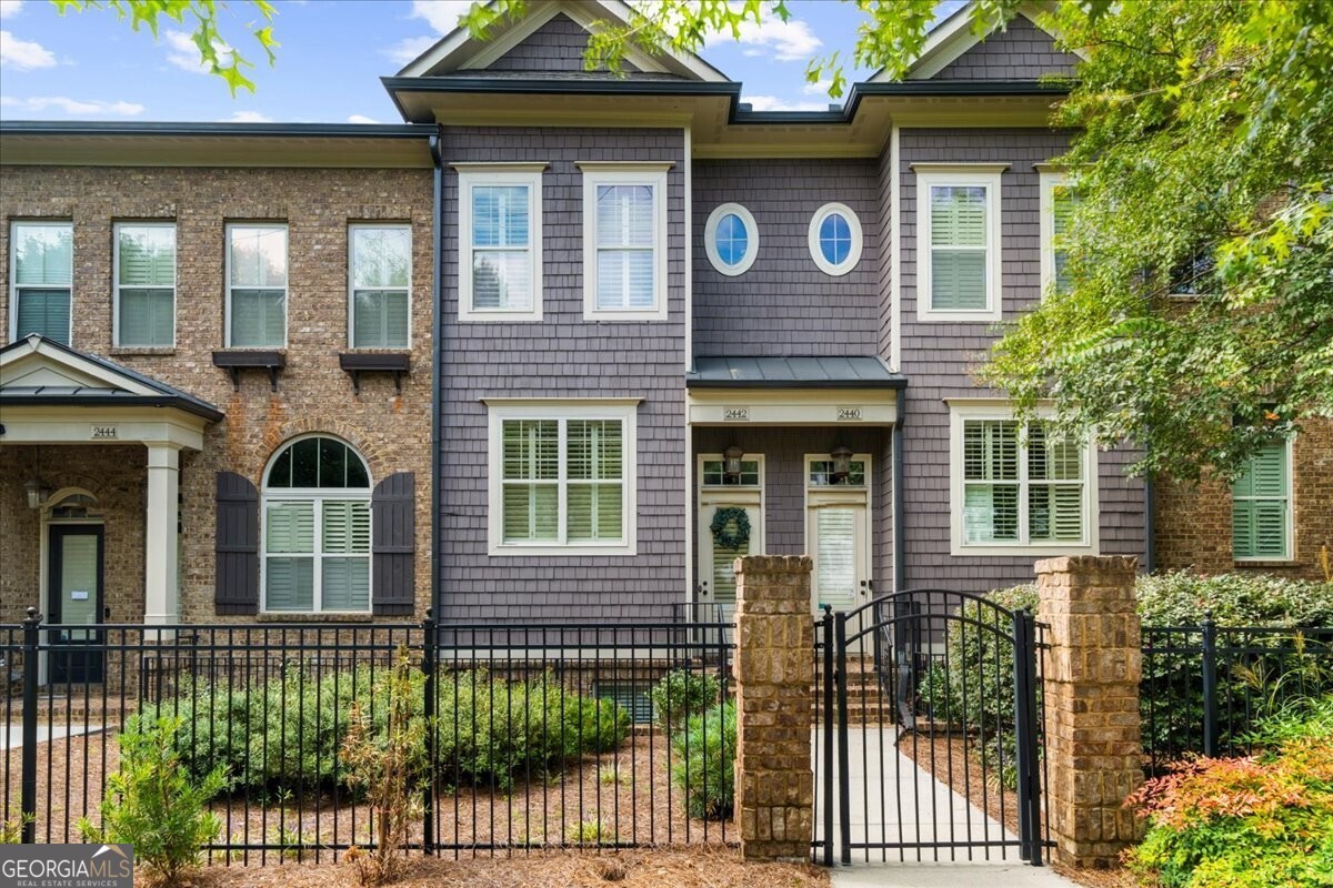 Beautiful Gated Townhome in the Heart of Chamblee Welcome to 2442 Gatebury Circle, a stylish and well-maintained townhome located in the highly sought-after gated community of Turnbury. Perfectly positioned just steps from restaurants, shops, coffee spots, and only minutes to Lowe's and major interstates, this home offers convenience at every turn. Inside, hardwood floors flow throughout an open-concept main level. The kitchen boasts granite countertops, abundant cabinetry, stainless steel appliances, a spacious island with beadboard detailing, and elegant finishes. A sunlit dining room sets the stage for entertaining or intimate meals, while the fireside family room provides a warm, inviting retreat. Step outside to a covered porch, ideal for morning coffee, evening gatherings, or weekend grilling. Upstairs, hardwood floors continue throughout, the expansive owner's suite features a spa-like bath with double vanities, a garden tub, a separate shower with a new glass door, and a generous walk-in closet. A spacious guest suite with a private en-suite bath provides comfort and privacy. Thoughtful touches like thick crown molding, shiplap in the half bath, and a statement wall in the upstairs bedroom add charm and designer flair. The lower level offers a flexible bedroom suite with a Murphy bed, brand-new carpet, and its own full bath, perfect for a home office, gym, or guest accommodations. With its unbeatable location and quality craftsmanship, this townhome is a rare find in one of Chamblee's most desirable communities. Don't miss the opportunity to make it yours!
