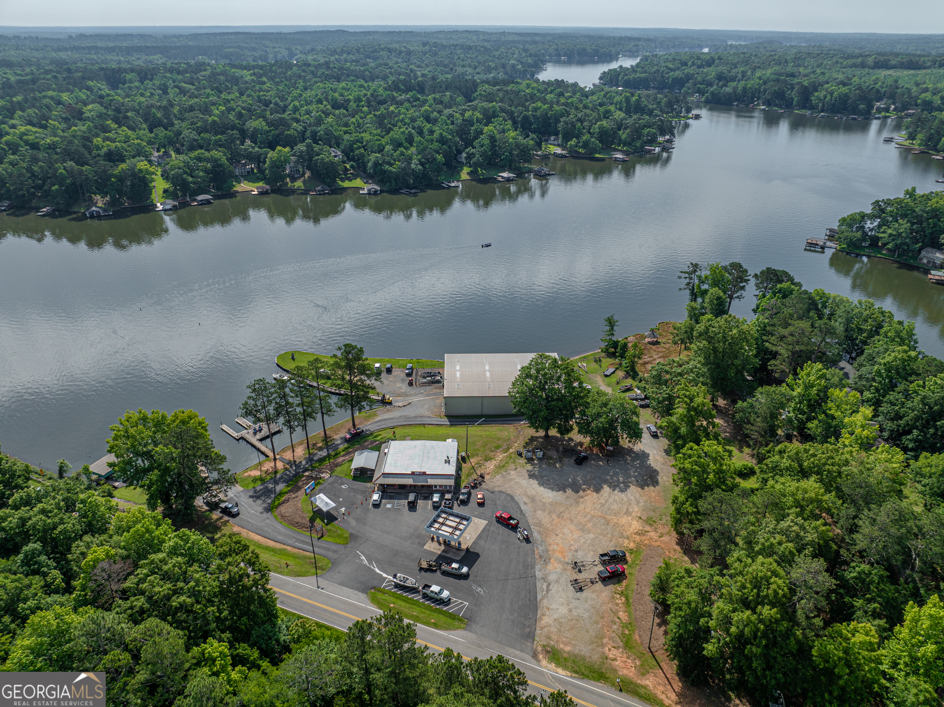 Nestled between the charming towns of Milledgeville and Eatonton, Georgia, Twin Bridges Landing offers an exceptional opportunity to own a full-service marina and convenience store on the picturesque Lake Sinclair. TBL offers breathtaking views of Lake Sinclair from every vantage point. Located on the northwest end of the lake, Twin Bridges Landing is the closest marina on Lake Sinclair to both Atlanta and Macon. It is situatied on the tranquil shores of Lake Sincliar, approximately 80 miles southeast of the the Atlanta airport, a 35 miles from downtown Macon. This property boasts convenient access from both Milledgeville (17 miles) and Eatonton (12 miles), making it an ideal destination for locals and visitors alike. The full service marina is equipped to cater to the needs of boaters, anglers, and watersports enthusiasts. The marina boasts top notch facilities including a 10,000 square foot boat storage facility, fueling docks, and expert maintenance service. The Convenience Store is stocked with everything you need for a fun filled day on the water. Whether you need live bait, fuel (both for the road and the water), cold refreshements, or snacks, the convenience store caters to both lake-goers and passersby, ensuring they have everything they need for a day on the water. It also has a full service deli if you are looking for a hot meal. Twin Bridges Landing isn't just a business-it's a community gathering place where locals come together to share stories, launch boats, make memories, and celebrate lake life. With a loyal customer base and a prime location, Twin Bridges Landing presents an excellent opportunity for entrepreneurs looking to invest in the thriving recreational industry. Twin Bridges Landing presents an unparalleled opportunity to own a premier lakeside destination on Lake Sinclair. Don't miss this opprotunity to make your mark in the heart of Georgia's Lake Country! This listing includes the marina, convenience store, and associated facilities, offering a turnkey solution for investors. Contact Jon Willoughby today to learn more about Twin Bridges Landing.