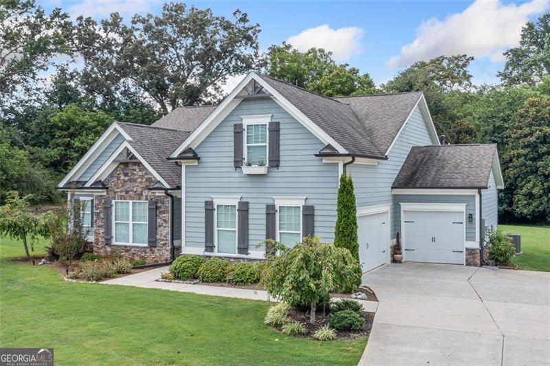 This exceptional four-bedroom, three-bathroom Stonecrest home blends comfort, style, and functionality in perfect harmony. From the moment you step inside, you'll discover an inviting layout designed for modern living, with spacious rooms and thoughtful details throughout. The open and airy interior features generously sized bedrooms, each with large walk in closets for ample storage. The primary suite offers a private retreat, while three additional bedrooms provide versatility for a home office or creative spaces. The upstairs room provides a private oasis with full bathroom, perfect for an in law suite or second master. Every bathroom is beautifully appointed with sleek tiled showers, creating a spa-like experience for your daily routine. Storage is abundant, with a convenient walk-in attic storage room and a three-car garage offering flexibility for vehicles, hobbies, or tools. Set on a large, beautifully lot, this property provides endless opportunities for outdoor enjoyment, entertaining, or future expansion. Enjoy the perfect balance of privacy and openness with room to relax, host gatherings, or design your dream outdoor oasis. The yard is equipped with a sprinkler system. Move-in ready and meticulously maintained, this home combines quality craftsmanship, thoughtful design, and exceptional convenience. Schedule your showing today and experience all it has to offer!