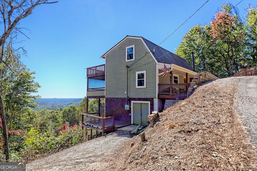 This is the story of 41 Ginger Lane. If you're looking for a home, on Screamer Mountain that can fulfill your highest expectations for a wonderful living experience, you've just found it.    41 Ginger Lane has what many locals call the million dollar view. The current owners decided to buy this home before even stepping inside by just driving up and seeing the magnificent mountain view spanning numerous mountain ridges in the far distance.    In the early morning you can see steam rising above the Chatooga River. When different weather patterns form in the valley, including some awesome mountain storms, you will have the best view, sometimes for hours on end.     Relax on one of the five porches, and after the storms you will often see a rainbow spanning the entire valley. It is truly a sight to behold.  Mount Currahee can be seen in the far distance. From almost every room in the house, you can view miles and miles of North Georgia mountain ridges that will take your breath away.    The prior owners meticulously figured out the puzzle of how to park up to five vehicles In the driveway   and the two side driving lanes. The carved out side of the mountain to the right of the driveway makes turning around a cinch as you head down the driveway from your mountain oasis.      When you enter the home, you will immediately be drawn to one of the three porches that span the width of the home. The phenomenal view can be seen from practically every room in the house ensuring you'll always be connected to its amazing natural beauty.     The porch on the main floor is completely screened for that time of year when bugs can be annoying, but not on this porch!  This porch is a constant get a way from the noise and drama of life.      It has been furnished to capture memorable mountain moments including the bar that seats four, the gas fire pit and the picnic table for a family gathering.  The ceiling string lights provide an evening atmosphere unmatched.     This home has been uniquely remodeled and redesigned over the past years. it is a different layout than most homes but this quirkiness is what makes this home very special for the right family. It will be a joy to live in this home.    Though technically a two bedroom 2 1/2 bathroom house, this houses' unique configuration can sleep as many as a dozen people.     It features two master bedrooms, one of which on the top floor has a curtained off area as large as many, second and third bedrooms in traditional home layouts.     The couch on the main floor is a fold out bed for children or anyone wishing to never leave the main floor of the house. Just move about this home and feel the flow and love that the three prior owners have managed to create through their individual tastes for mountain living.    We think you'll receive positive comments from your visitors for years to come.    The half basement on the bottom floor has a large workshop area with plenty of shelving including a work table.  Outside this workshop area you'll find a small deck where two or more people can sit in isolation from the rest of the occupants and still have the magnificent view.     Access to the fenced in back yard is from the half basement through the double doors that leads to another side deck and an open porch and then to the gate entry for the fenced in yard.    The description below will give you the interior features so use your imagination to see how you can make this fit your lifestyle. Follows are the features of the home, but remember the only way you will ever capture the feel of this home is to walk through it and imagine yourself living here and enjoying all of the benefits provided.     Two of the prior owners were custom home builders and the third had an equal imagination and did some incredible things that you will not find in other homes in the North Georgia mountains. So here are some traditional elements of the home but these elements do not tell the story of 41 Ginger Lane.