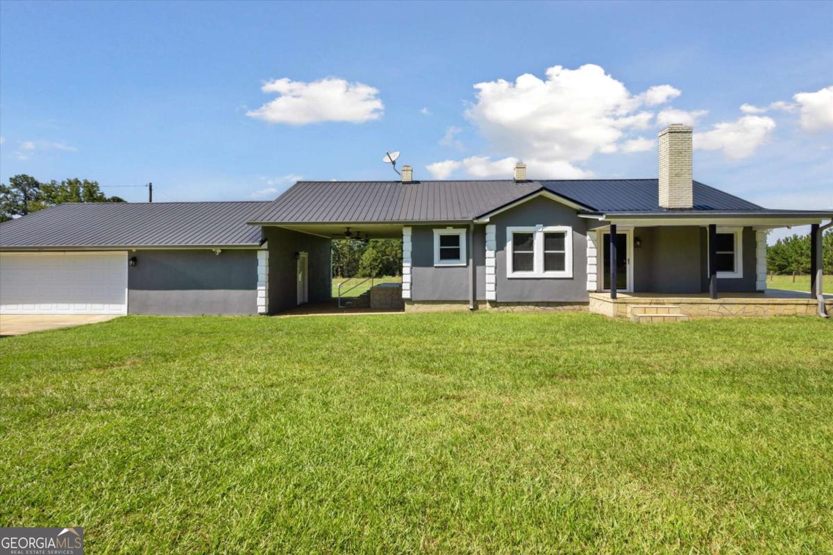 Embrace the simple life in this charming 2-bedroom, 1-bath home situated on an incredible 2.46 acres of open land. The home features a thoughtfully designed layout that maximizes every square foot, offering a welcoming living area and comfortable bedrooms. The single bath is conveniently located to serve the entire household. An oversized garage adds even more functionality, complete with a convenient half bath-perfect for projects, hobbies, or extra storage. The entire property is fully fenced and gated, providing both privacy and peace of mind, and it already comes equipped with a security system and cameras for added protection. The true highlight of this property is the land itself. With over two acres of pristine, open space, you have the freedom to create the outdoor lifestyle youve always wanted. Build a workshop, plant an orchard, or simply enjoy the vast, open views. This unique property provides a peaceful, private setting while remaining close to the conveniences of modern life. Its the perfect place to put down roots and build a future.