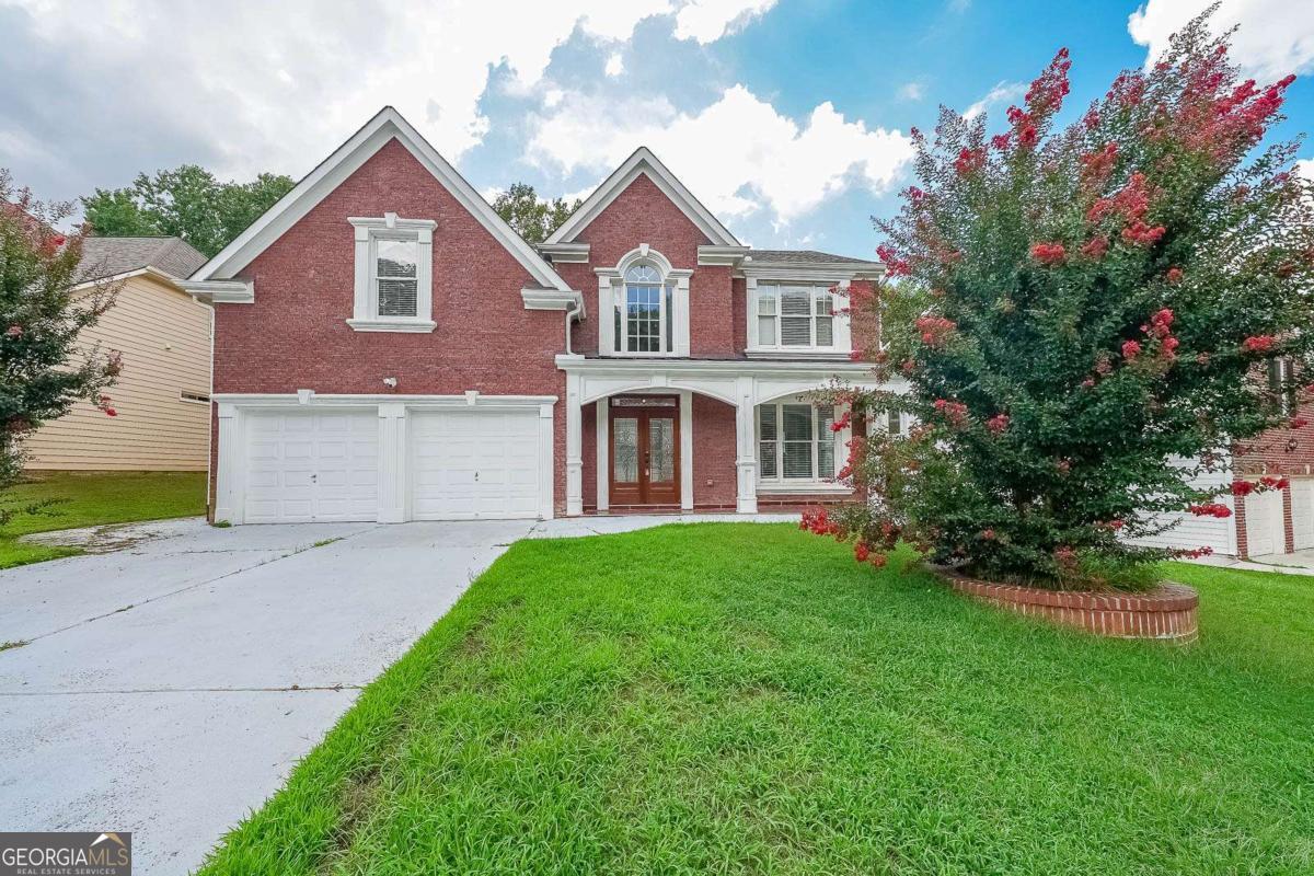 This stunning 5BD/3.5BA home is your chance to live in the highly sought-after Knollwood Lakes community - an active swim and tennis neighborhood featuring a clubhouse, playground, lakes, and a pavilion with picnic tables. From the moment you walk in, you'll feel right at home. The two-story foyer and hardwood floors set the tone, complemented by approximately $50K in crown molding throughout. The home also features upgraded flooring with elegant new tile, adding style and durability in all the right places. The two-story Great Room boasts a cozy fireplace, coffered ceilings, and large windows that flood the space with natural light - all flowing seamlessly into the kitchen. This gourmet kitchen offers stainless steel appliances, granite countertops, and a pantry, making it perfect for both everyday living and entertaining. Step outside to your covered back patio, ideal for relaxing after a long day, overlooking a fully fenced backyard with a storage shed for extra convenience. Upstairs, the Owner's Suite is a private retreat with tray ceilings, a separate sitting area, a walk-in closet, and a spa-like bathroom with double vanities, a jetted tub, and a separate shower. Four additional bedrooms, including a Jack-and-Jill bathroom, provide ample space for family or guests. Enjoy easy access to Hwy 124, Sugarloaf Pkwy, Hwy 316, and I-85, plus shopping, dining, parks, and entertainment just minutes away.