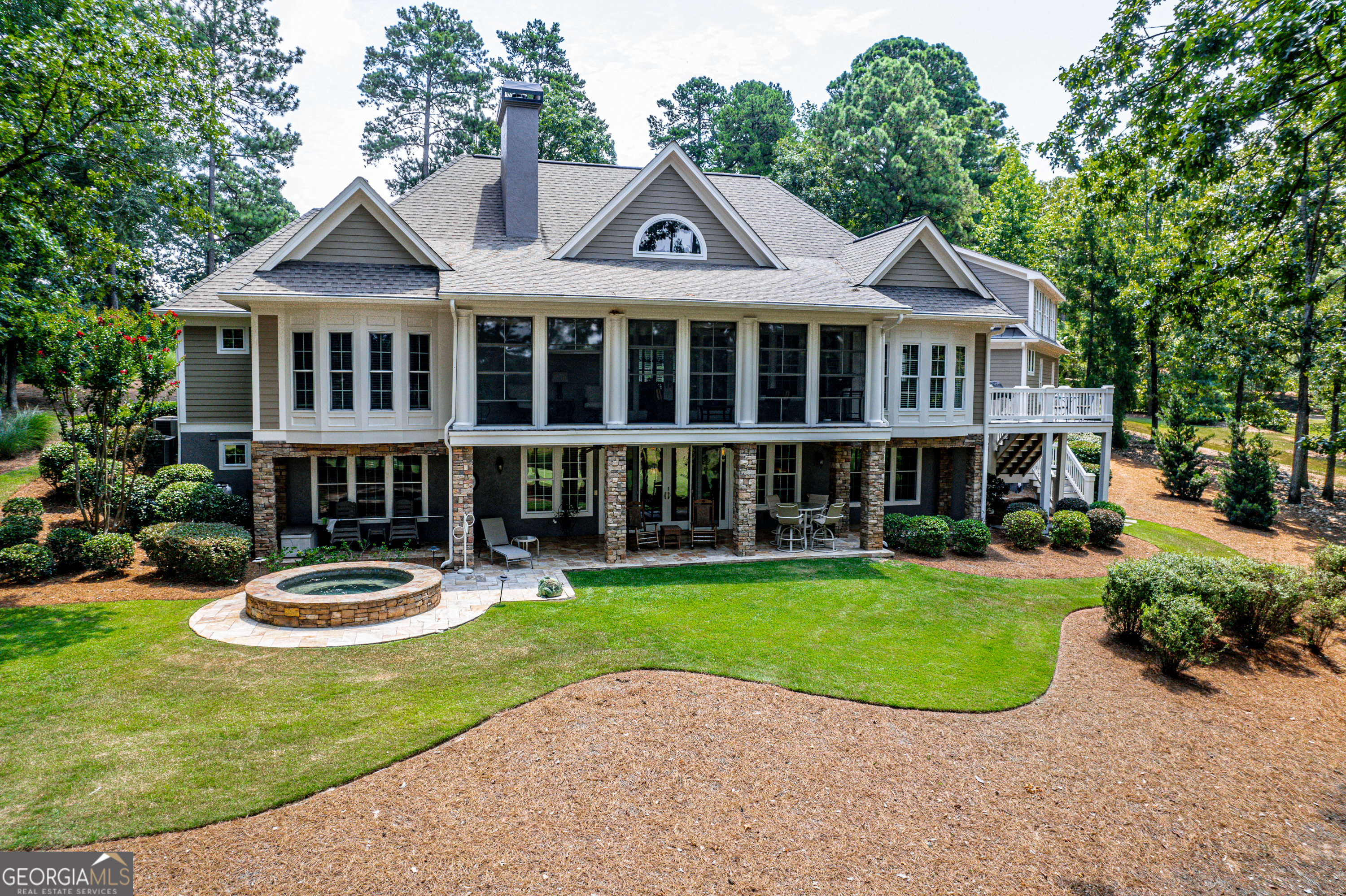 Private 1.81-acre home with a water view on Richland #15 with stunning views of The Tom Fazio designed National golf in highly sought after Reynolds Lake Oconee Golf Estate. Exterior of the home has new fresh paint as well as the terrace level Rec room, bedrooms, terrace level baths, kitchen cabinets, bookshelves in family room, and the entire main level has fresh paint. All gutters have a complete set of gutter guards. Totally updated home with a true Chef's dream kitchen featuring new kitchen appliances a Wolf double oven, Wolf 6 burner stove top, Wolf refrigerator, and new Wolf microwave. New Kohler sink and faucet, new kitchen lightening, new backsplash tile in kitchen and butler's pantry wet bar. New kitchen quartz countertops. Warming drawer for the Chef to keep food at the desired temperature for a designated period of time, or for slow cooking needs. The Owner's Suite boasts new oak hardwood flooring, new carpet in owner's closet, and new ceiling fans. The owner's suite has a relaxing view of the golf course and pond, an oversized sitting area, new quartz bathroom countertops, new lighting, new toilet, steam shower with two shower heads, and new Kohler sinks and faucets. Unwind in the large hot tub while listening to the upgraded Sonos system throughout the home or outside. 3 new Sono's amps just added to the existing Sonos system allowing for music to be directed to all rooms. Newer LVP flooring in Terrace level, 2 ice makers in the wet bar and terrace level bar. Enjoy the refrigerator and use of dishwasher while entertaining guest at the terrace level bar. New lighting fixtures in the dining room and foyer. The garage is an oversized 2 car garage with actual space for 2.5 cars. This gives plenty of room for a motorcycle or other item that needs storage. This home has been meticulously maintained with attention to detail and updates to enhance the beauty of the property with functional items such as large closets, lots of storage, and a very private property that complements Lake Oconee luxury living. Don't miss this opportunity of finding the perfect property to call home in luxury Reynolds Plantation.
