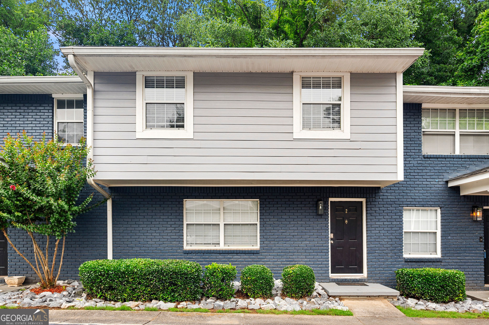 Welcome home to your own quiet, spacious, and beautiful condo in the heart of Brookhaven, next door to CHOA's newest campus, Emory University, and all things ATL. Perfectly positioned for both comfort and convenience, this home offers easy access to Buckhead, I-85, 400, and the Peachtree Creek Greenway - the beautiful and expanding greenway invites outdoor enthusiasts with a private gate across from the community saltwater pool and lawn area, perfect for a step away from the urban setting. Featuring gleaming hardwood floors throughout, the condo allows for a quiet retreat in the middle of midtown. The upstairs has the spacious primary suite with a full bath and two secondary bedrooms with a full bath in the hall. The hall bath has a full-size washer and dryer stack. The downstairs entry opens to the great room with modern lights, a ceiling fan, and wiring for your wall-mounted screen. Around the corner to the nice dining room overlooking the back porch and nature preserve. The kitchen is updated and thoughtfully laid out with stone countertops, a lazy susan pantry, a new range, and ample cabinet space. A convenient half bath is off the kitchen. The new HVAC is two years old. If the generous closet space is not enough, extra storage is available in the basement of the next building. HOA fees cover clean and well-kept amenities, gated security, landscaping, and building maintenance, as well as water, sewer, and weekly trash pickup. Owners have two assigned parking spaces directly in front of their unit, with additional guest parking sprinkled throughout. Go ahead: imagine the possibilities!