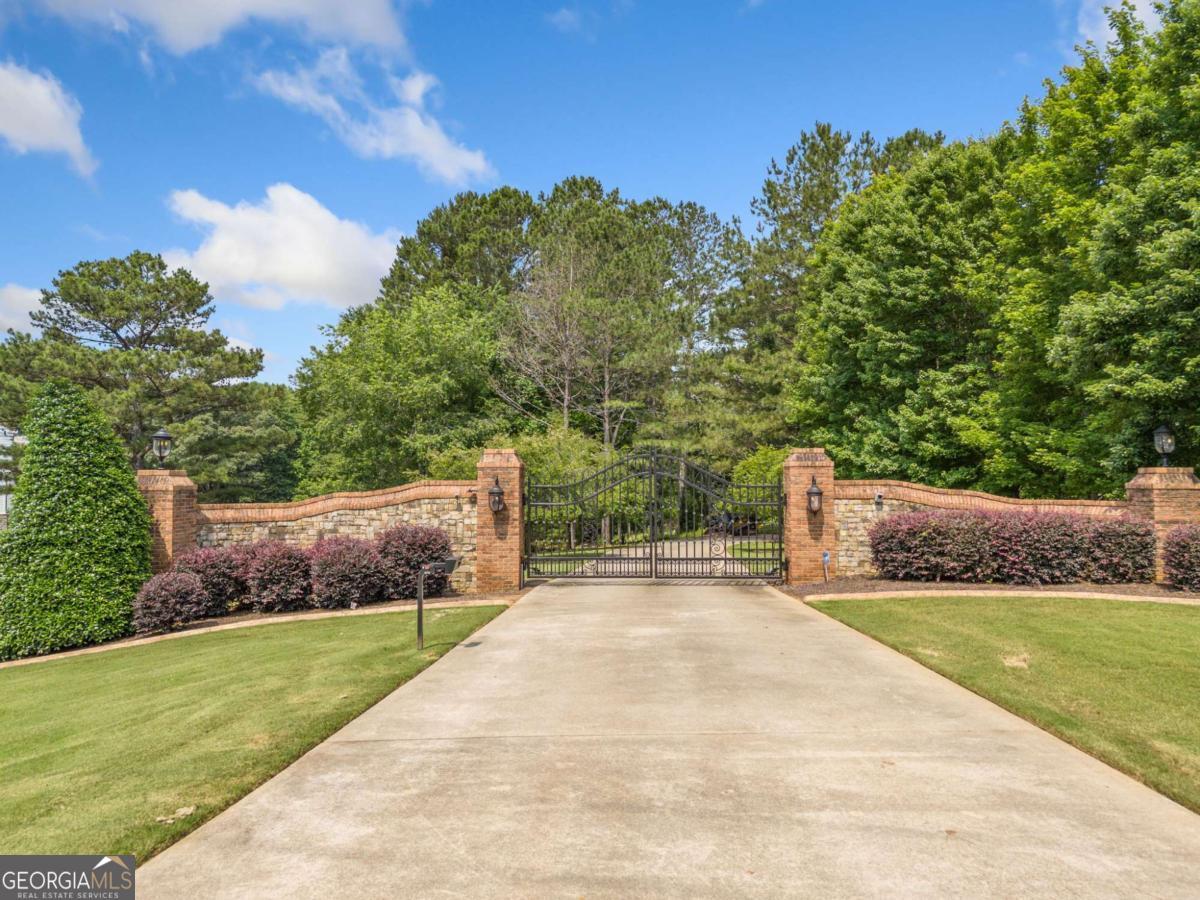 3.10 acres in The Enclave-a private, gated community-lot #4 nestled in a quiet cul-de-sac and backing to the golf course. Build your dream home in this peaceful, prime location. This property is perfectly positioned on the White Columns golf course. Membership at White Columns Country Club is available separately. Prospective homeowners may reach out to White Columns Country Club to learn more about membership options and amenities, including golf, tennis, swimming, and social events.