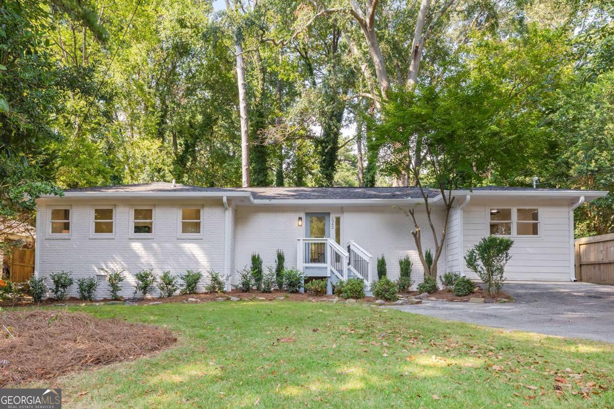 Looking for a like-new, one-level home (without the million-dollar price tag)?... THIS IS IT! This Chamblee beauty was taken down to the studs and rebuilt with PERMITS-essentially new construction with all the modern upgrades you've been searching for. No detail was spared: brand-new roof, windows, HVAC, plumbing, and electrical systems, plus designer finishes throughout. The open-concept floor plan is a showstopper with vaulted ceilings, a bright chef's kitchen, and seamless flow into the living and dining spaces. The spacious primary suite and spa-like bath are tucked on the main level along with three additional bedrooms. Outside, enjoy the walk-out backyard-perfect for entertaining, pets, or playtime. This home is truly custom-not builder grade-and offers worry-free living in a prime location. Just minutes from Buckhead, Brookhaven, I-85, CHOA, and the upcoming Peachtree Creek Greenway, it combines style, convenience, and peace of mind. You won't find another Intown home with this level of renovation and detail at this price point. THIS IS IT!