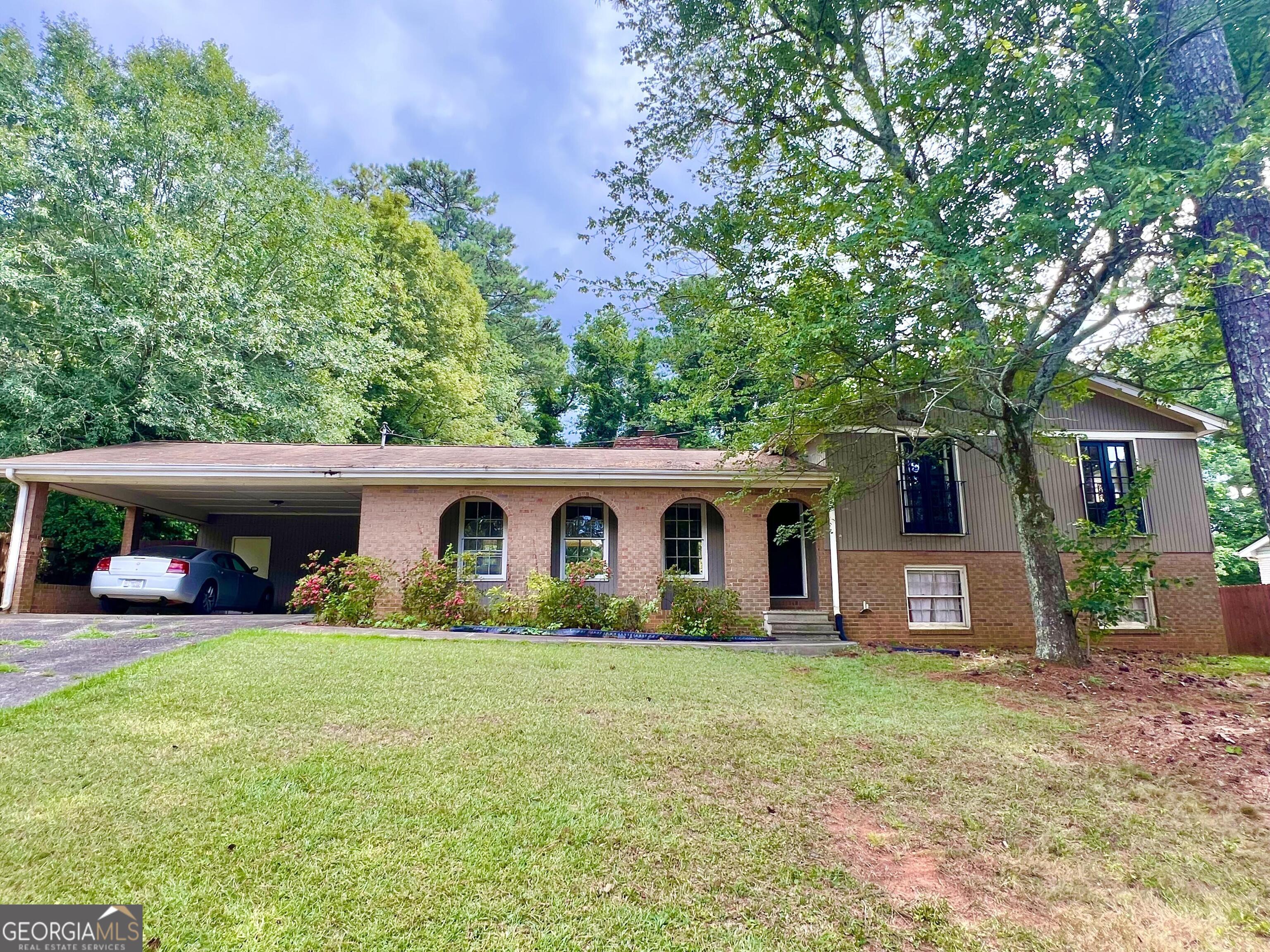 DEAL OF THE SUMMER! Instant Equity is yours with this charming brick split level resting in a peaceful neighborhood with established homes. Remodeled homes in this area are selling for well over four hundred thousand dollars. Premiere location with award winning schools and nearby shopping, dining, & entertainment. This home is designed to host the fun with its four bedrooms, three full bathrooms, formal dining room, open floor plan, and covered back patio. Even includes a large private fenced-in back yard for your pets and young ones to play. This home features a fun & unique design with its arches over the rocking chair front porch, a cool & calming space to relax and wind down after a hard days work. Compelling opportunity to add your personal touch with some minor TLC, catering to any family or first time home buyer looking to capture tremendous upside on day one. Opportunities like this are hard to find, so act now, before it's gone.