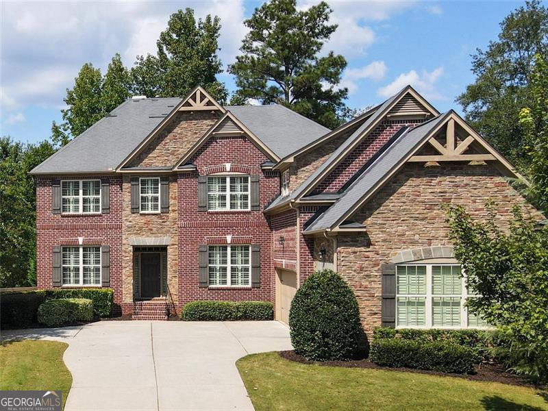 Welcome to this beautifully designed home offering space, style, and convenience in one of the area's most desirable swim/tennis neighborhoods. Step into the main level, where a private office sits to the left and a formal dining room to the right, creating the perfect blend of function and elegance. The heart of the home is the open-concept living area, featuring a dramatic two-story wall of windows, a stunning stone fireplace with built-in surround, and seamless flow into the spacious kitchen and breakfast room. The kitchen is as practical as it is inviting, with plentiful cabinetry, a pantry, bar seating at the island, and easy access to the garage. Step out from the breakfast area onto the deck, offering both covered and uncovered spaces ideal for year-round outdoor entertaining. A main-level bedroom with a full bath makes a perfect guest suite or multigenerational option. Upstairs, retreat to the luxurious primary suite with vaulted ceilings, an attached sitting room, and a spa-like bath boasting a huge shower, separate soaking tub, and dual vanities. Three additional bedrooms upstairs include one with its own private bath and two connected by a jack-and-jill. The unfinished terrace level, already stubbed for a bath, is ready for your personal touch, whether you envision a media room, home gym, or additional living space. Outside, the beautifully landscaped yard enhances the home's curb appeal and provides a peaceful backdrop. All of this is located just minutes from Avalon, Downtown Alpharetta, and Milton's charming shops and dining, with easy access to top-rated schools and community amenities.