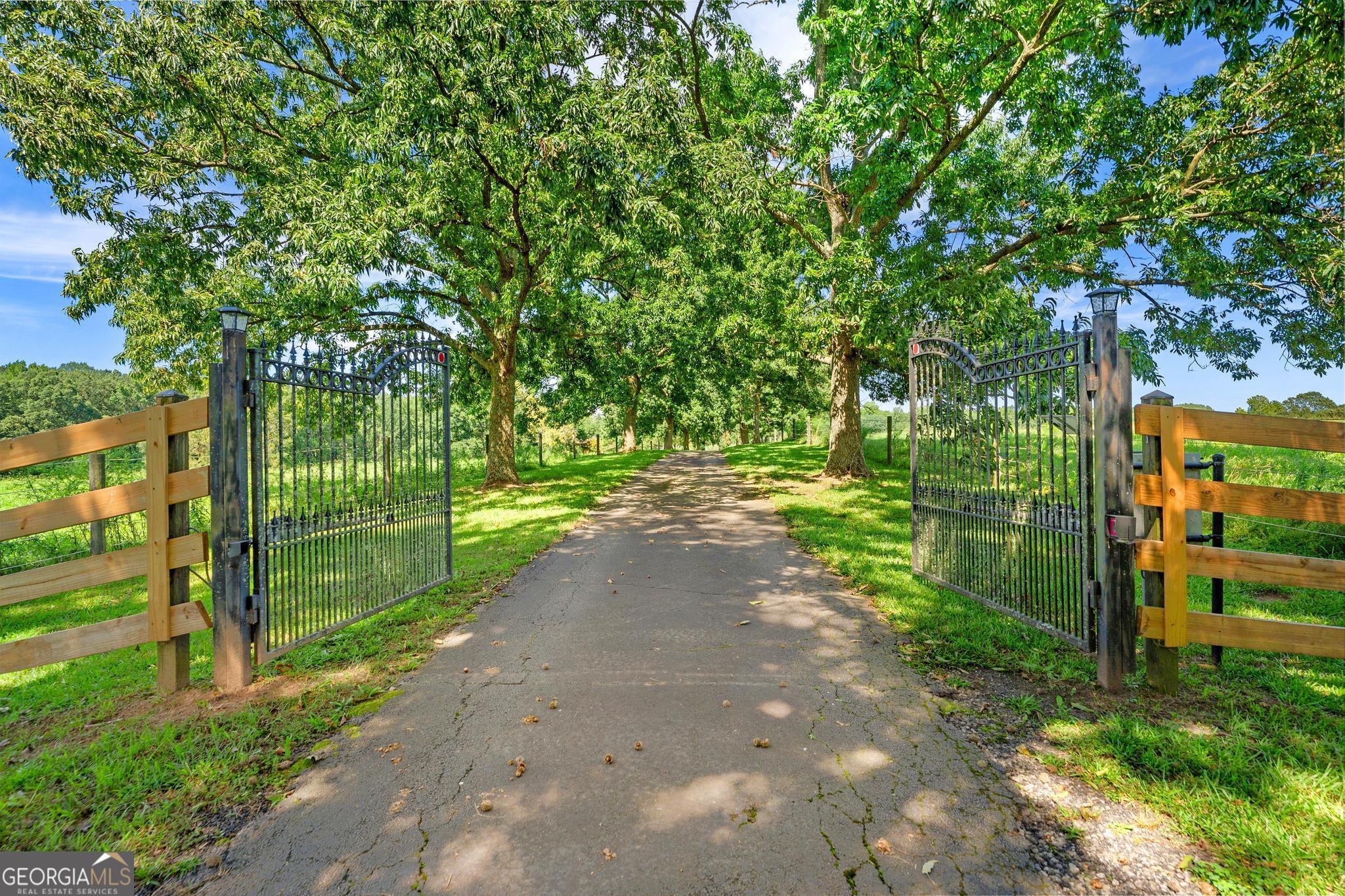 Welcome to 886 Hudson Rivers Church Road! Enter the gates at the top of the drive and take a breath. Surrounded by 24.56 acres of SERENE open pastures, there is plenty of grazing for a small herd of cows, horses, or other livestock. The front yard is a picturesque OASIS of hardwoods with plenty of room to create outdoor living space. The backyard is fenced with several dog runs within and also has a deck that has been recently stained for more enjoyable outdoor living. The INVITING knotty pine Pergo floor is in excellent condition and is seen throughout the living room, dining room, kitchen, and breakfast room areas. Recently painted, new carpet in all bedrooms except the room with burgundy carpet, new well in 2023 that is 325' deep and produces 50 gallons/minute.************************* Stroll to the main horse barn where there are three 12x15 foaling stalls, three 12x12 regular stalls, and a 10x12 stallion stall with a paddock. There is a feed room, cross ties, a palpation chute, and two additional paddocks (one 60x60 and one 60x40). The lower barn has 6 stalls, lights inside and out, a loft with a deck outside THAT IS CURRENTLY NOT SAFE TO STAND ON. PLEASE BEWARE. 1 stall is connected to a paddock. The 24x24 hay barn can hold 500-600 bales of hay and has a cow head chute next to the barn. In front of the hay barn, there is a trainer tack compartment.********************** The 60 foot Rocking W round pen is adjacent to the lower barn. The arena (which currently needs remediation due to grass growing in it) is 90x200 with very bright LED lighting. There are two separate storage buildings on the property; one was used for storage and one was used for tack. There are flood lights on every barn as well as on the house. This property became vacant on 8/21/2025 and is ready for new life to fill the house and the barns.