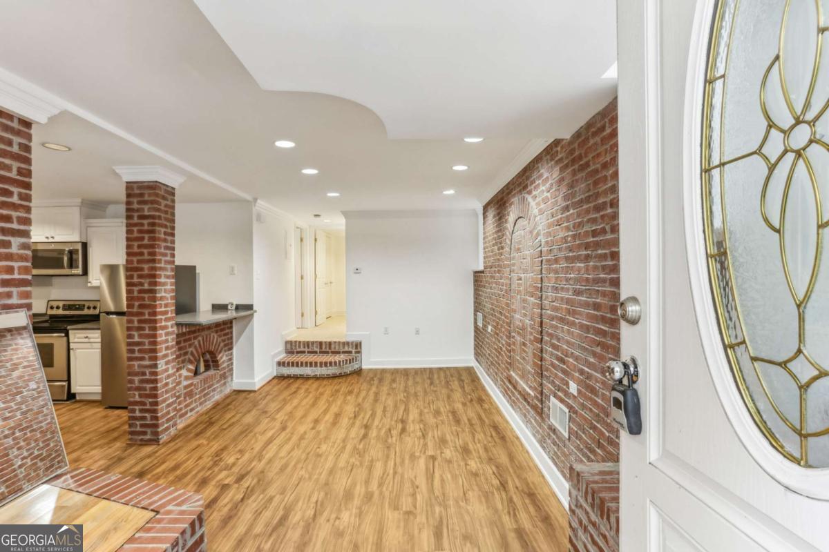 Corner/end unit walk in level condo walking distance to Virginia Highland! Highland Hall community sits minutes from Virginia Highland shops/restaurants, Emory, Fernbank, Inman Park, Candler Park, Ponce City Market, Beltline, O4W, Midtown, and more. Unit B25 features new paint, new LVP flooring, new carpet, exposed brick, flat ceilings, thermal windows, recessed lighting, 2 bedroom spaces, 2 full bathrooms, and a covered private patio with tile. The kitchen includes corian counters, large counter space, white cabinetry, and stainless steel appliances. Additional highlights are stacked laundry in the unit, large closets, community pool/grilling area, and dog run. Highland Hall provides outstanding walkability and a short commute to many intown attractions.