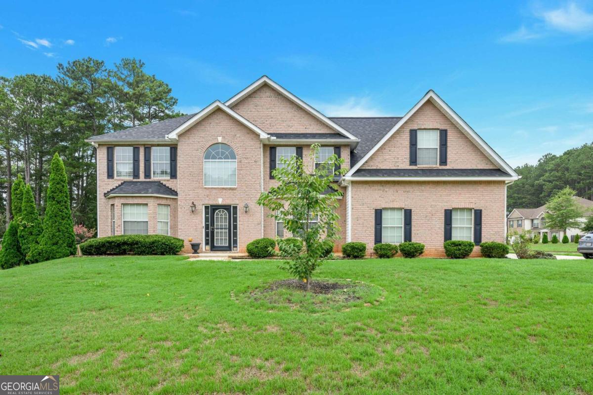 This spacious brick-front, two-story home combines elegance and comfort, offering a formal living room and a separate dining room perfect for entertaining. The kitchen, equipped with stained cabinets and ample countertop space for meal preparation, opens up to a cozy family room featuring a fireplace, ideal for family gatherings. On the main floor, there's one bedroom and a full bath, providing convenience and flexibility. Upstairs, the oversized master retreat impresses with its generous space, walk-in closet, and a luxurious master bath complete with double vanities, a soaking tub, and a separate shower. The secondary bedrooms are also spacious, ensuring comfort for family members or guests. The nicely sized level backyard offers a great space for outdoor activities and relaxation, making this home a perfect blend of functionality and charm.