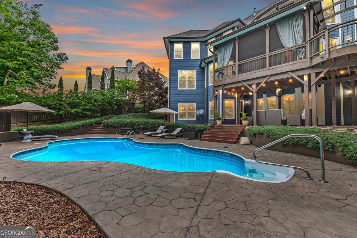 Welcome to your private retreat in the heart of Dacula's Chapel Estates-where thoughtful updates and curated luxury come together. The main level features sunlit living spaces with freshly refinished hardwood floors, fresh interior paint, and a beautifully upgraded kitchen with professional-grade appliances and a smart refrigerator. The layout flows effortlessly into a light-filled sunroom and out to a custom outdoor oasis featuring a saltwater pool, covered stone bar with built-ins and TVs, and an adorable shed perfect for storage or weekend projects. Upstairs, the layout is just as practical as it is elegant, offering a convenient number of bathrooms to match the spacious bedrooms, along with elevated details like tray ceilings that bring warmth and character to the home. Downstairs, the finished basement offers endless possibilities-whether you keep it as the ultimate entertainment zone with a pool table, poker room, full, custom-made bar, and home theater, or reimagine the private room and full bath as a guest suite, home office, or gym. Water-resistant flooring was thoughtfully chosen to suit indoor-outdoor living. Major upgrades-including a newer roof, AC unit, gutters, and full exterior paint-offer peace of mind for years to come. The fenced backyard glows with LED accents, and the three-car garage provides space for hobbies or storage. Ideally located just minutes from Hwy 316 and I-85, with easy access to everyday conveniences like Publix, shopping, and the exciting new Harbins Road development featuring restaurants, retail, and more-this home is the one you've been waiting for. Schedule a showing today!