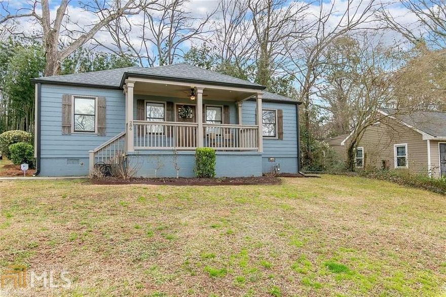 Up high on the lot with a welcoming & covered front sitting porch, this home was completely renovated 4 years ago so you can just move in and enjoy.  Modern, open floor plan includes enormous, light filled living room, dining room and white kitchen with island and breakfast bar, SS appliances, granite counter tops, custom white cabinets & pantry.  2 bedrooms, 1 bathroom down a hallway off the living room & another 2 bedrooms & 1 bathroom off of the back, including the huge master suite with walk in closet, large shower, double vanity and view of private back yard.