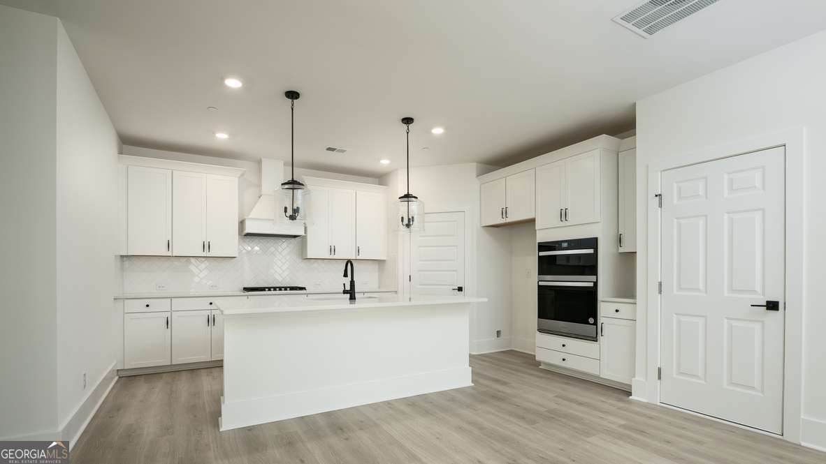 This stunning Harbor floorplan in East Cobb's newest gated community, Village at Sandy Plains, showcases a perfect blend of modern style and functionality. The open-concept plan offers 5 bedrooms and 4 baths in a layout ideal for entertaining. A spacious gourmet kitchen featuring sleek quartz countertops, a vented wood hood, stainless steel appliances, and a large island that flows seamlessly into the dining and living areas. The main living space on the first floor boasts 9-foot ceilings, finished with durable RevWood flooring that flows to wood stairs with an open railing. Upstairs, you'll find a versatile loft that's perfect for additional living or working needs. The oversized primary bedroom provides ample space for a sitting area retreat, while the secondary bedrooms are thoughtfully placed on the opposite side of the home for privacy, with a convenient Jack-and-Jill bath. Elevated finishes throughout the home, craftsman details on the exteriors and a gated swim community make this home a must see. Located in a prime Marietta location, this property offers easy access to the Marietta Square, top-rated schools, shopping, dining, and major highways. It's a truly extraordinary place to call home.