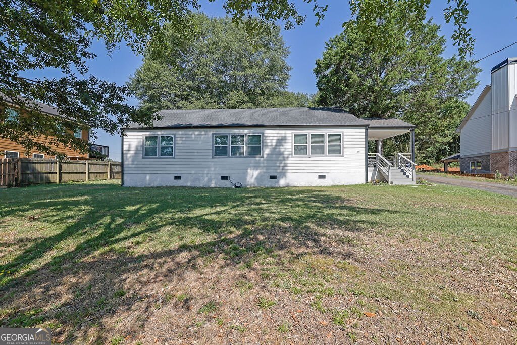 Step into timeless charm with modern updates at 280 Stone Mountain Street-a beautifully renovated 3-bedroom, 2-bath ranch located just steps from the heart of historic downtown Lawrenceville. Built in 1938 and thoughtfully updated, this home combines classic curb appeal with today's conveniences in a location that offers the best of walkable living. Inside, you'll find soaring ceilings, luxury vinyl plank flooring throughout, and an open-concept layout that makes everyday living and entertaining a breeze. The kitchen is the centerpiece of the home-featuring granite countertops, white shaker cabinets, a crisp subway tile backsplash, and stainless steel appliances. The oversized primary suite includes a private ensuite bath with a walk-in shower and modern tile work, while two additional bedrooms share an updated full bath with fresh finishes. Enjoy your morning coffee or unwind after a long day on the inviting side porch-a peaceful spot with room for rocking chairs, potted plants, or evening chats. The spacious backyard offers a blank canvas for gardening, entertaining, or simply spreading out, and there's a detached storage shed for all your tools or hobbies. Just a short stroll from the historic square, the Aurora Theatre, local dining, and year-round festivals, this home offers both convenience and character. A rare opportunity to own a move-in ready gem in the heart of one of Gwinnett County's most beloved downtowns. Make a great deal even better with Massive savings through special loan programs with the Preferred Lender Envoy Mortgage with Aubrey Wilcox! Ask the Listing Team for the introduction for up to 100% Financing or even interest rates in the 4s!