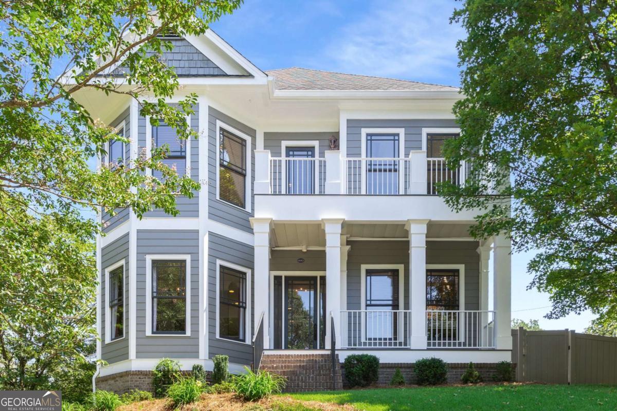 Live in the heart of Oakhurst! This lovely 4-bedroom, 3.5-bathroom traditional residence puts Oakhurst Village at your fingertips, offering a vibrant lifestyle filled with restaurants, shopping, festivals, and more. Step inside via the inviting covered front porch to a beautifully maintained interior that effortlessly meets all your needs. The main level welcomes you with high ceilings and an abundance of windows, creating a sun-soaked atmosphere. Enjoy peaceful moments in your foyer reading retreat nook or host gatherings in the elegant formal dining room. The bright kitchen, featuring white cabinets and sleek black appliances, flows seamlessly into the cozy family room adorned with window-lined walls and a wood burning (gas starter) fireplace, perfect for creating a warm ambiance. Step outside onto the new back deck made with Fortress Infinity deck boards providing a maintenance-free outdoor space to relax and enjoy your private, fenced yard. Upstairs, the expansive master retreat beckons with a bay window sitting area, his and her closets, and a spa-like en-suite bathroom boasting separate vanities, a large soaking tub, and a glass-enclosed shower. Just outside the master, the second-story deck offers a perfect spot for stargazing or enjoying front-row views of Oakhurst festivals. Two additional sizable bedrooms with soaring ceilings and an adjoining stylish bathroom complete this level, ensuring comfort and privacy for everyone. The lower daylight level, accessible through the main house or a private entrance, presents a versatile space ideal for an in-law or guest suite, featuring multiple rooms for various uses, along with a full bathroom and unfinished storage. Additional highlights include tankless hot water heater, hardwood floors throughout, fresh paint, new Fortress Infinity decking on all porches and decks. Embrace the best of Decatur with coffee shops and restaurants just steps away, and enjoy easy access to downtown Decatur, highways, and the airport for a quick getaway or work travel. Don't miss the chance to make this exquisite home your own!