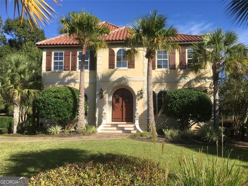 "SANIBEL MANOR HOUSE AND GARDENS!" It features an old-world Mediterranean Revival architectural design. It takes you back in time welcoming you to a simpler, more elegant era. The interior is a beautiful masterpiece of craftsmanship! It was carefully restored and renovated from 2019-2021. During this time, new HVAC was installed along with upgrades to the roof, plumbing, and flooring. Custom wood shutters and blinds were installed throughout the home along with custom lighting. The upstairs balcony has a beautiful arched stained-glass window that overlooks the neighborhood. The lovely botanical gardens were designed and constructed with the help of skilled landscape professionals, masons, electricians, and more than a dozen vendors from across SE Georgia. The gardens feature sculptured water fountains, classical statuary, brick-paved walkways, a wide variety of tropical trees and plants, and two lovely ivy-covered arched trellises. It is truly a haven of beauty and tranquility. Sanibel Manor House and the botanical gardens are beautifully illuminated at night presenting an enchanting panorama! The nighttime illumination transforms the manor house, landscape, and botanical gardens into a picturesque world of dramatic colors and evocative shadows. Being far from the city lights, overhead the evening sky is filled with the brilliance of a thousand stars and the occasional shooting star. Sanibel Manor House and Gardens is a truly magical place to enjoy and love!!