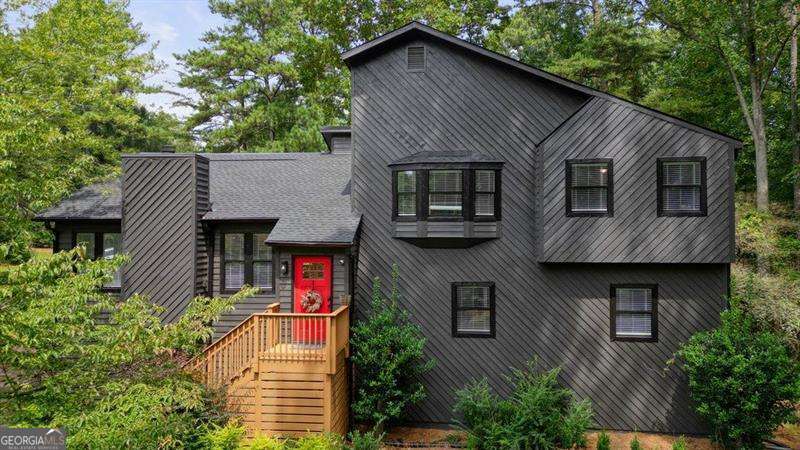 Welcome to this beautifully renovated 5BR/3BA contemporary home in the sought-after Lassiter High School District! This stunning updated home has been renovated inside and out. Step into the front entryway and be welcomed by soaring vaulted ceilings, an abundance of natural light, and an open-concept living space that creates a seamless flow throughout. Enjoy fresh interior and exterior paint, luxury vinyl plank flooring in the main living areas, primary suite, and downstairs bedroom, with plush carpeting in the secondary bedrooms. The open-concept living area features a stunning stone fireplace and a fully renovated kitchen with quartz counter tops, stainless steel appliances, a coffee bar, additional storage, and a drink fridge for added convenience. The bright and airy dining area opens to sliding glass doors leading to a newly stained deck-perfect for entertaining or enjoying a peaceful evening outdoors. Upstairs, you'll find a fully renovated guest bathroom, two spacious guest bedrooms, and a large primary suite. The primary suite includes a luxurious en suite bathroom with a large walk-in shower, custom wood wall treatment, double vanities, and a walk-in closet with custom built-ins. On the lower level, there's a second family room, two additional bedrooms, and a beautifully updated Jack and Jill bathroom-ideal for modern living. The laundry room on this level offers extra storage with built-in shelving and access to additional crawl space storage. Situated on a large corner lot, this home features a fenced-in backyard with mature trees for tranquility. Additional updates include a brand-new roof (2025), new HVAC system (2024), and a new water heater (2024). HOA for this community is an Optional Voluntary Association.