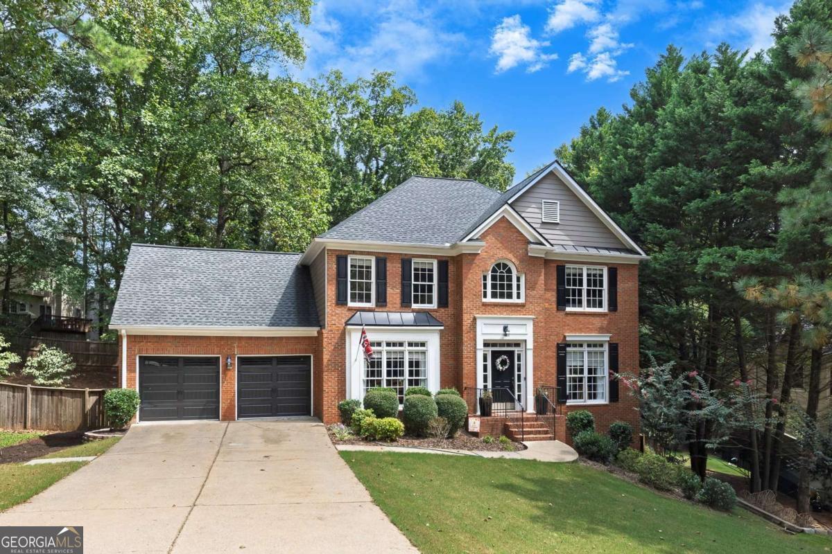 Welcome to this stunning 5-bedroom, 3.5-bath home with over 4,000 sq ft in the highly sought-after Wyngate community of Towne Lake. Nestled on a quiet street, this home features an open kitchen with granite countertops, white cabinetry, stainless steel appliances, and a breakfast bar that flows into the living room and a light-filled keeping room with wet bar. The main level also offers a separate dining room, while upstairs you'll find generously sized secondary bedrooms and a spacious owner's suite with a private bath. The fully finished walk-out basement includes a bedroom, full bath, flex space, and large living room-currently an incredible Atlanta Falcons fan cave-perfect for entertaining or guests. Step outside to an expansive deck overlooking the fully fenced private backyard, ideal for gatherings and play. Recent updates include a newer roof, garage doors, and HVAC, giving peace of mind for years to come. Enjoy the unmatched amenities of Wyngate with two pools, clubhouse, tennis and pickleball courts, playgrounds, and community events-all paired with top-rated schools in a prime Towne Lake location.