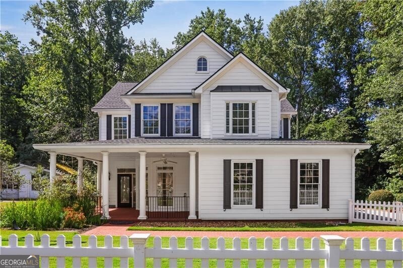 AWESOME 5 bedroom home near the Marietta Square and in West Side Elementary School District! Beautiful level 1/3 acre level lot with mature trees in the back and a large deck overlooking a play area. 2 Primary suites - the larger upstairs with a huge bathroom, double vanity, walk in shower, separate tub and 2 large closets. A second primary suite on the main level with a full bath and a zero-entry shower! Wonderful kitchen with a farmhouse sink, stainless appliances, granite counters, and opens directly to the huge den and a breakfast nook. Precious sun room on the rear of the home plus a separate dining room and an open living space/office at the front door. Upstairs features a huge laundry room, custom shelving, 3 full bedrooms plus the primary suite (AKA 4). Real hardwoods through the main level AND the upstairs primary bedroom! Plantation shutters on almost every window. Huge 2.5 car garage. Separate outbuilding workshop that has electricity and a mini-split unit. Large driveway with ample parking. TONS of storage! Great neighborhood close to the Square. 2023 New hot water heater and laundry room renovation, 2021 both HVAC units replaced, 2020 brand new roof, 2019 all new carpet