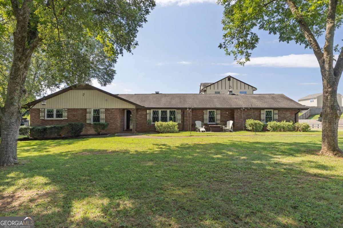 Discover this versatile four-sided brick ranch on 1.58 acres, offering multiple options for generational living. The main home features 3 bedrooms and 2 full baths with a bright, open floor plan that seamlessly connects the living room, dining area, and kitchen - ideal for family time and entertaining. There is also an office already set up for at home working or crafting! Enjoy real hardwood floors, a kitchen with granite countertops, updated cabinetry, stainless steel appliances, and a spacious pantry. The oversized owner's suite includes a spa-like bath with a jetted tub and separate shower, while two additional bedrooms share a modern hall bath. An attached in-law suite provides its own full kitchen, living room, office/flex space, bedroom, bathroom, and private entrance. A shared laundry/mudroom with sink conveniently connects the two spaces. The property also includes an attached three-car garage with a finished bonus suite above, complete with a full bathroom - perfect for guests, an apartment, or home office. Outdoors, you'll find a fenced backyard, newer shed, and deck. Living space breakdown: Main home: 2,169 sq. ft. / In-law suite: 717 sq. ft. / Garage apartment: 840 sq. ft. for a total of 3,726 sq. ft. (per appraisal). Recent updates include: added new field lines for septic system (2021), new windows for entire home (2022), replaced cast-iron plumbing (2023), rebuilt deck and stairs (2024), and added insulation (2025). This home has been thoughtfully maintained and updated - ready for its next chapter. Schedule your showing today!