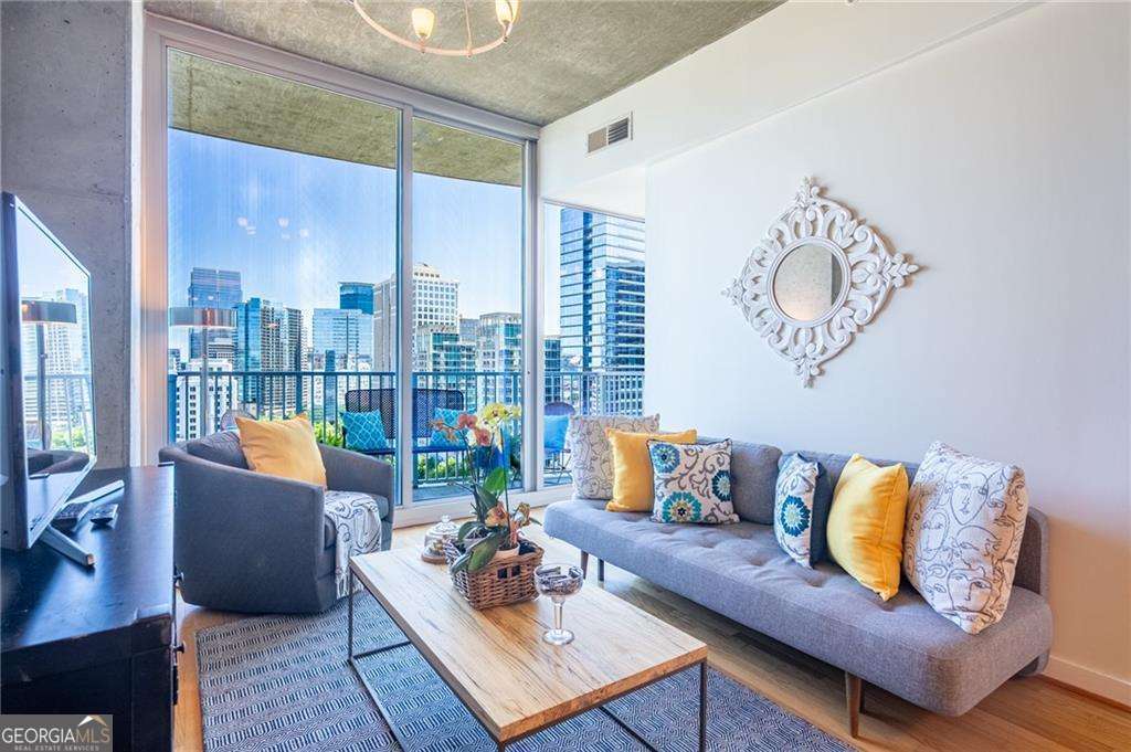 Spectacular and sophisticated unit in Atlanta's renown "SPIRE"! Open the door to immediate and unobstructed views north into Midtown's breath-taking skyline containing some of the City's most notable landmarks while providing a panoramic view into a truly world-class city. Hardwood floors, exposed concrete, floor-to-ceiling-windows, and designer colors make this home a treasure in the sky. Whether you're looking for a year-round residence or a pied-a-terre for those special "get-aways", this unit has all for which your heart could hope while meeting every need for a comfortable urban lifestyle. Spire is known for its full array of amenities...from the professionally managed concierge staff (24 hours) to the spa-quality resident services including club room, business center, theater, exercise facility, pool, and out-door kitchen area...truly, a city within a city. Private, covered parking; secure access; and on-site management all provide carefree living. This IS the place to be to enjoy the hustle and bustle of Midtown's most fashionable mile while claiming a coveted "Peachtree Street" address. Check out the photos and schedule your appointment today. Don't let this wonderful property, at a very affordable price, get away.
