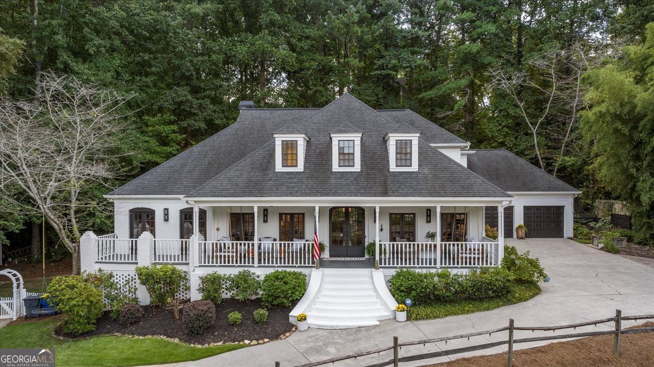 Escape the everyday and arrive at your own private sanctuary in the coveted Fields Pond community. A winding drive past a serene neighborhood pond leads you to a home completely hidden from the road, offering unparalleled seclusion on a wooded cul-de-sac lot. This charming Cape Cod welcomes you with an expansive front porch perfect for enjoying tranquil water views with your morning coffee. Step inside to discover a thoughtfully designed floor plan with refinished hardwood floors throughout the main level. The heart of the home is the beautifully updated kitchen which has been opened to the family room, creating an ideal space for entertaining. A true cook's delight, it features granite counters and stainless appliances. Host elegant dinners in the formal dining room with French doors that open to the porch breeze, or retreat to the convenient main-level primary suite offering private deck access. Upstairs, four additional bedrooms provide ample space for family and guests. The basement can be a perfect independent living or multigenerational space with minor modifications. The basement also has a workshop and a large storage area. Host gatherings on the flagstone patio or find a quiet moment in the garden. Fully fenced backyard! With recent updates including the roof, exterior paint, and HVAC, plus community pool and tennis, this home combines ultimate privacy with modern comfort.