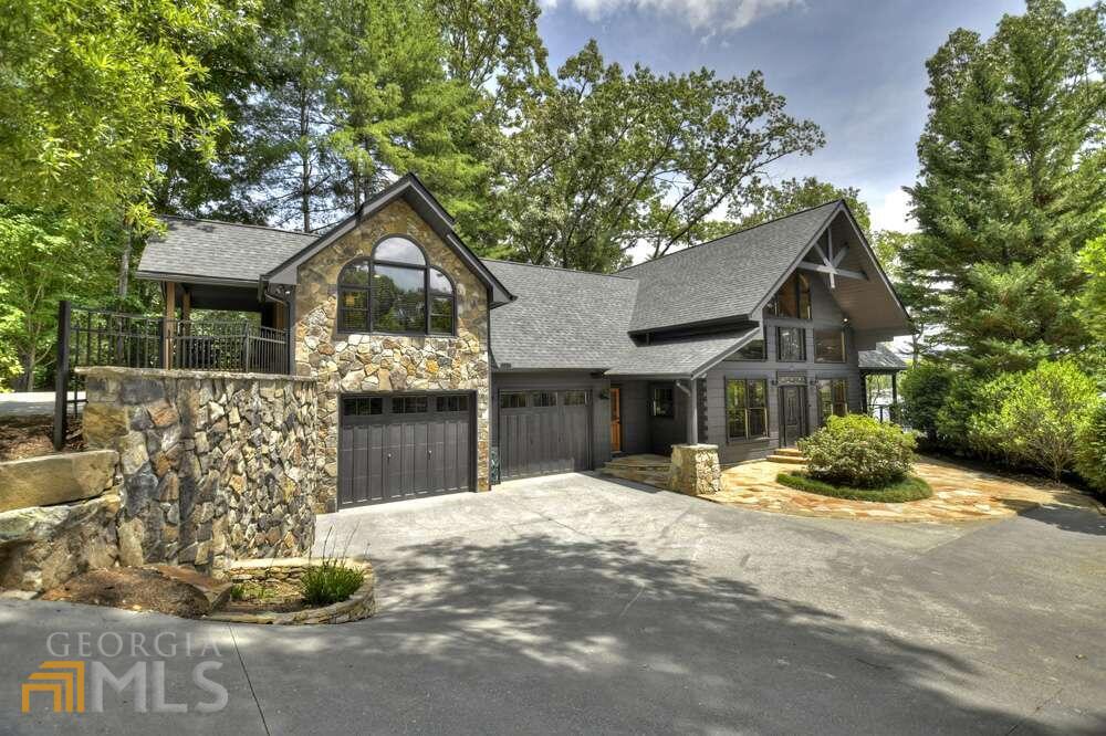 COMPLETELY UPDATED AND RENOVATED....this lakeside estate is perfectly located on Blue Ridge Lake w/year-round deep water and just minutes to downtown Blue Ridge on all paved roads! Offering fully renovated 5 bedrooms all w/private bathrooms complete w/custom tile & countertops, spacious open floor plan w/kitchen-dining-greatroom showcasing wall of windows with LONG-RANGE VIEW OF LAKE AND MOUNTAINS, upstairs & main level master suites, private office w/wetbar, finished terrace level w/fireplace and recreation room, level & gentle walk to new dock & shoreline restoration, professional landscaping & irrigation, new roof & exterior painting, whole-house generator, 2-car garage and a long private circular driveway allowing privacy from the road. Ready for move-in immediately to enjoy lake life-style in hottest area of Blue Ridge!! Complete list of renovations available upon request!