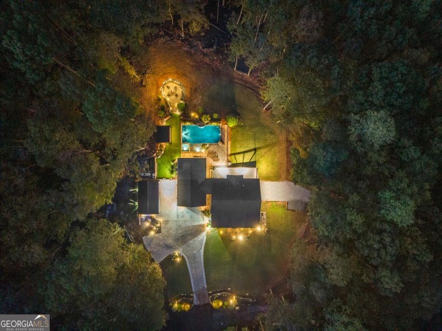 Welcome to your own private retreat nestled on 5 acres of pure tranquility. This stunning custom home offers the perfect blend of luxury, comfort, and entertainment, designed for those who love to live, relax, and host in style.    Step outside to your backyard paradise, featuring a custom gunite pool and hot tub spa, surrounded by lush landscaping and peaceful privacy. Gather around the outdoor fire pit, enjoy dinner from the outdoor kitchen, or cozy up by the outdoor fireplace under the stars. Whether it's a quiet evening at home or a weekend gathering with friends, this space has it all.    And for the entertainers - get ready to make memories on your very own outdoor music stage, perfect for live performances or special celebrations.    Inside and out, this home is designed for those who value space, serenity, and sophistication. The fully finished basement adds even more possibilities - ideal for a media room, gym, or guest suite. Located just minutes from AMP Motor Sports Park and Iron Mountain. Your dream home awaits - where every day feels like a getaway.