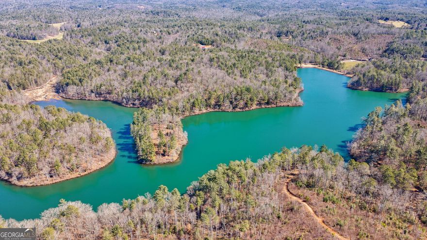 First time on the market! Extremely rare and unique 977 acres with 70-Acre private lake. Multiple potential build sites on the lake or choose a higher elevation with amazing, breathtaking, long-range mountain views. The property features multiple creeks and approximately 3500 feet of border with the U.S. National Forest. Property also has miles of unpaved trails in place. Whether you choose to fish, boat, hike, bike, camp, hunt, ride ATV's, watch wildlife, or just relax this property offers all of it and more. A cabin is waiting for some TLC to make it a great spot to rest and recharge after enjoying the land and water. You absolutely must see this property to understand how special it is. The Property was newly surveyed in 2024 and is being sold "As-Is."  *Showing by appointment only. Property is gated. Please do not attempt to enter the property without a showing appointment.    For more information call listing Agents:  Chip Carter (678.327.8111) or Travis Ebbert (706.614.8840)
