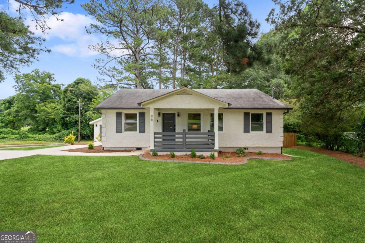 This completely move-in-ready home recently underwent a full renovation and is located in a sought-after location just around the corner from adorable downtown Fairburn and two blocks from Landmark School! Situated on a beautiful corner lot, this home boasts upgraded electrical and plumbing systems as well as newer HVAC, water heater, and roof. Inside, the finishes are everything you are looking for -- From the white kitchen cabinets, black pearl leathered granite counter tops, and full suite of stainless steel appliances to the luxury vinyl flooring throughout, the touch screen vanity mirror + new flooring, doors, windows, and shades, this home truly has it all! You'll love the modern conveniences like the bluetooth garage door opener and the bidet with a heated seat. The home has charm, character, and all the modern updates and finishes you are searching for in your new home! Newly poured concrete driveway with additional parking pad/turnaround area is another huge expense that wasn't spared on this amazing opportunity to own in the best location in Fairburn. The large, fully-fenced backyard features a beautiful deck perfect for entertaining and enjoying the outdoors. Have a dog? They will love the backyard!! Don't have a dog? This yard is begging you to get one! In addition to being just minutes to shopping, dining, and retail, you can get to Hartsfield-Jackson International Airport in about 13 minutes!! The proximity to sporting events and concert venues in downtown Atlanta will be the cherry on top for this great location! This home is the most turn-key property at this value for the area to be this close to downtown Fairburn and Landmark School, so don't let this opportunity pass you by, and schedule your showing today!